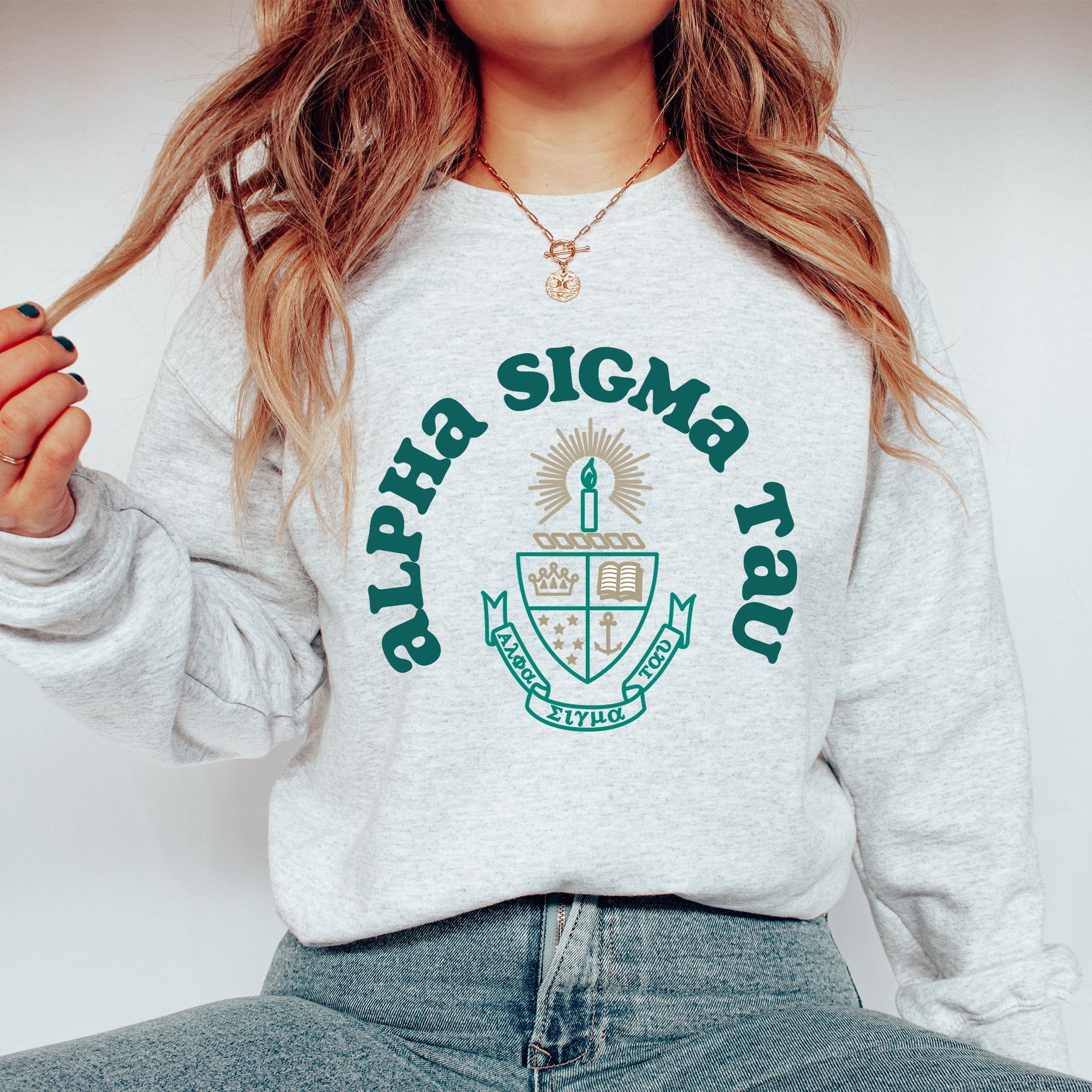 a woman wearing a sweatshirt with a crest on it