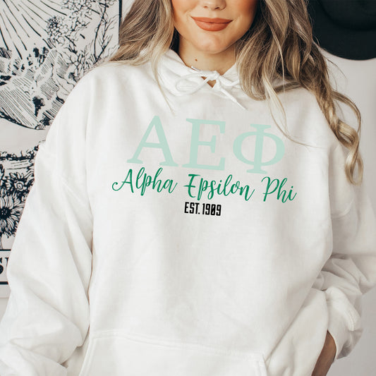 a woman wearing a white hoodie with green lettering