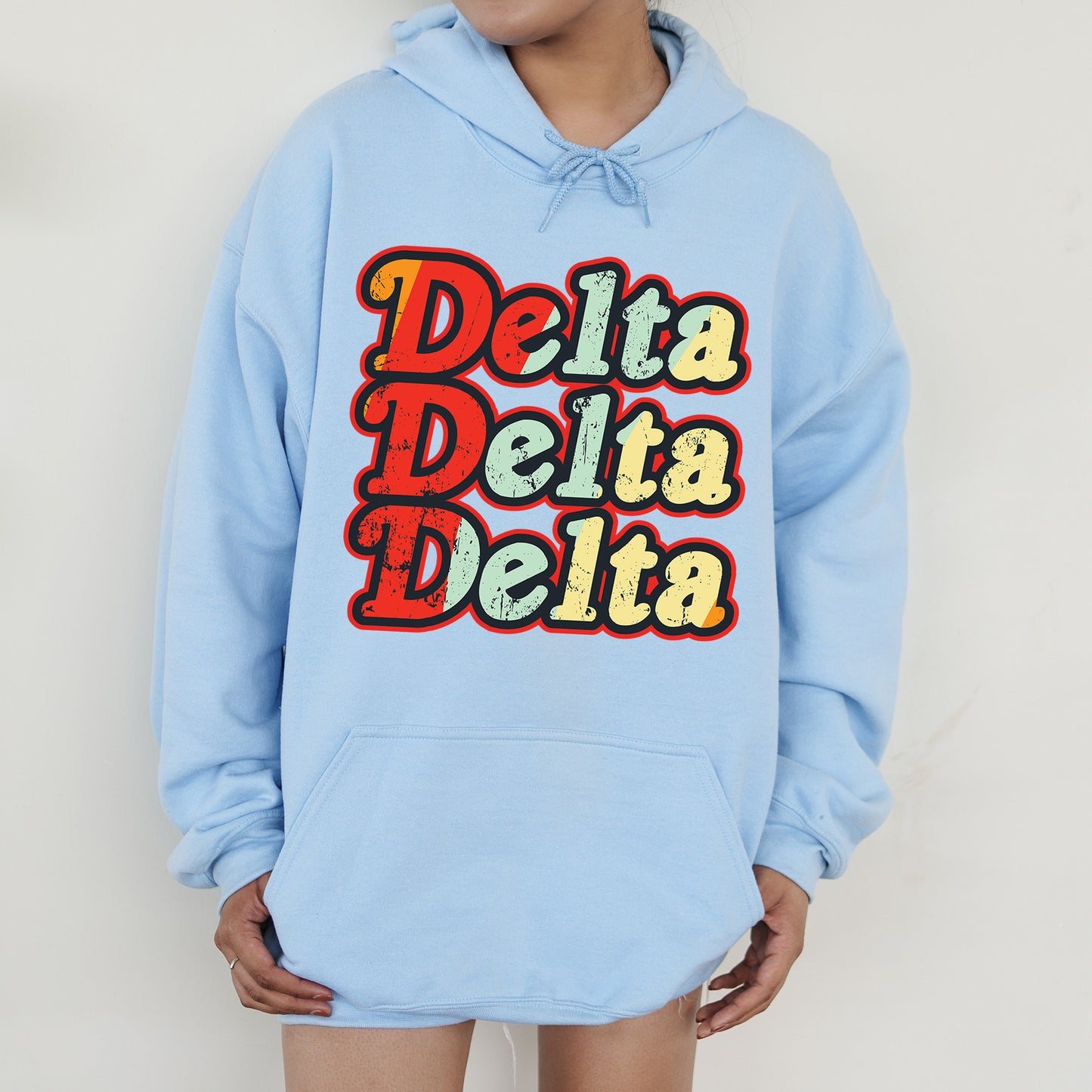 a person wearing a blue hoodie that says delta delta delta