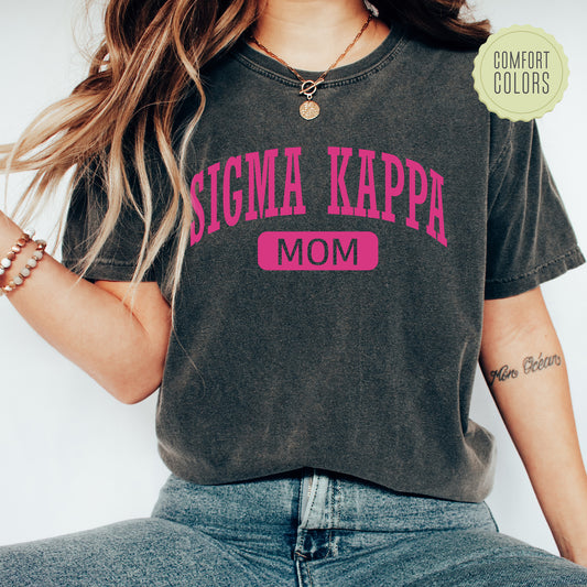 a woman wearing a shirt that says stigmaa kappa mom