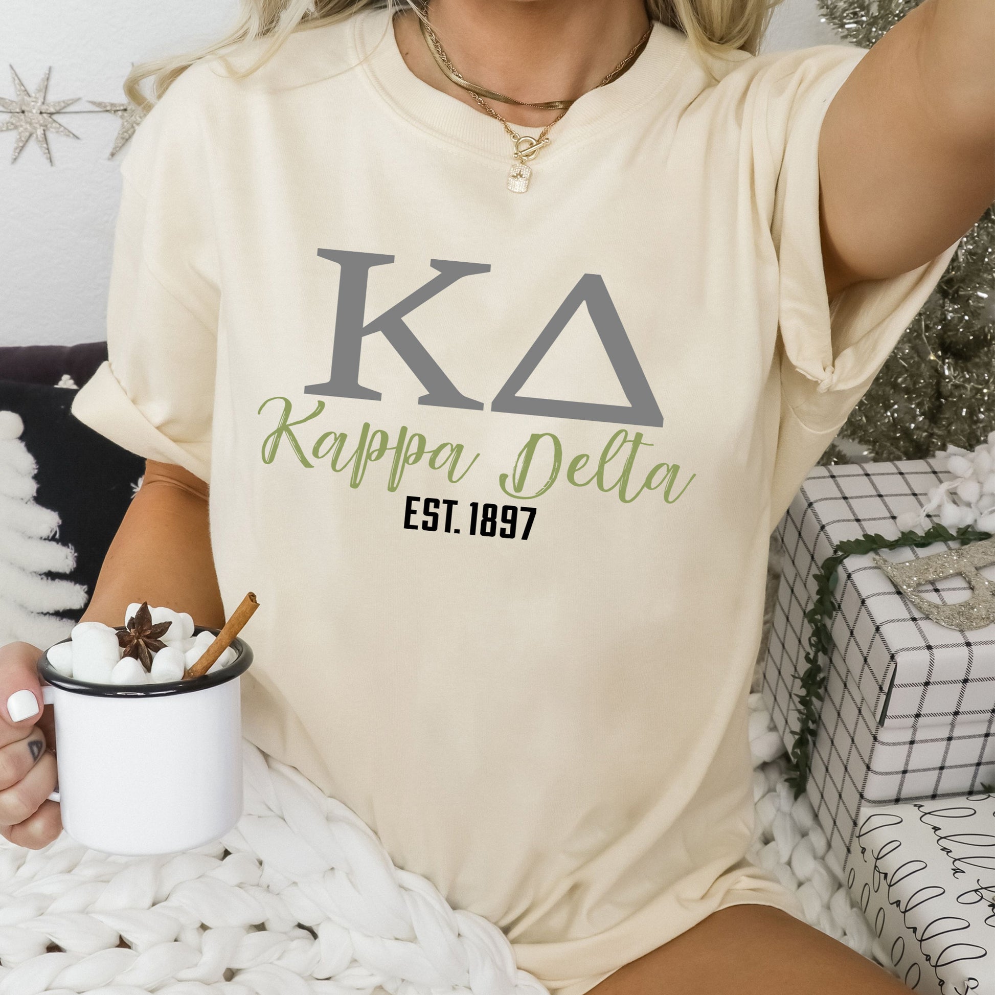 a woman sitting on a bed holding a cup of coffee