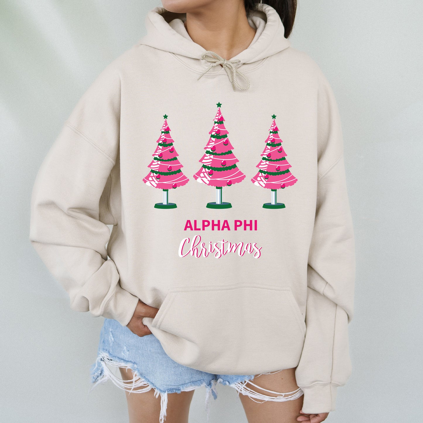 a woman wearing a sweatshirt with christmas trees on it