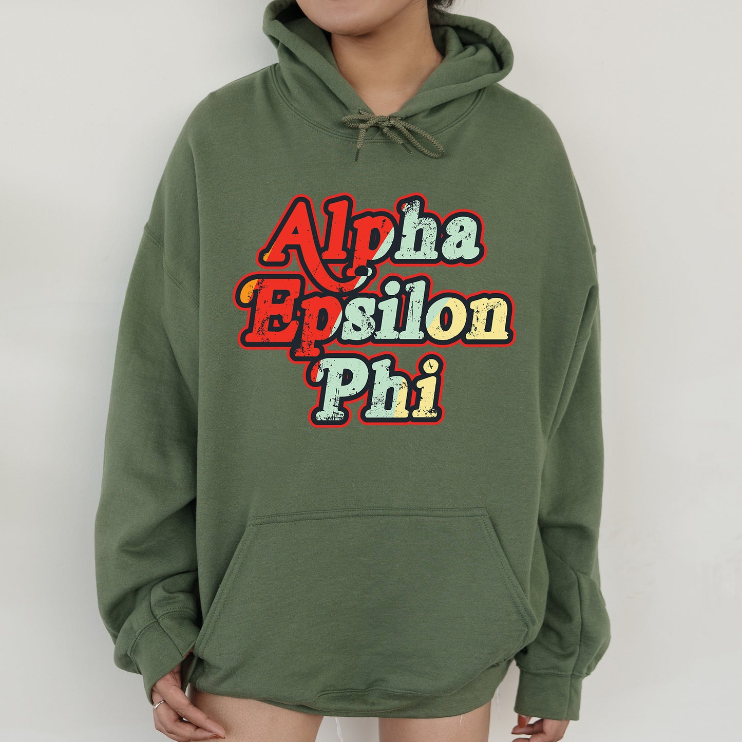 a person wearing a green hoodie with the words aloha boston phi on