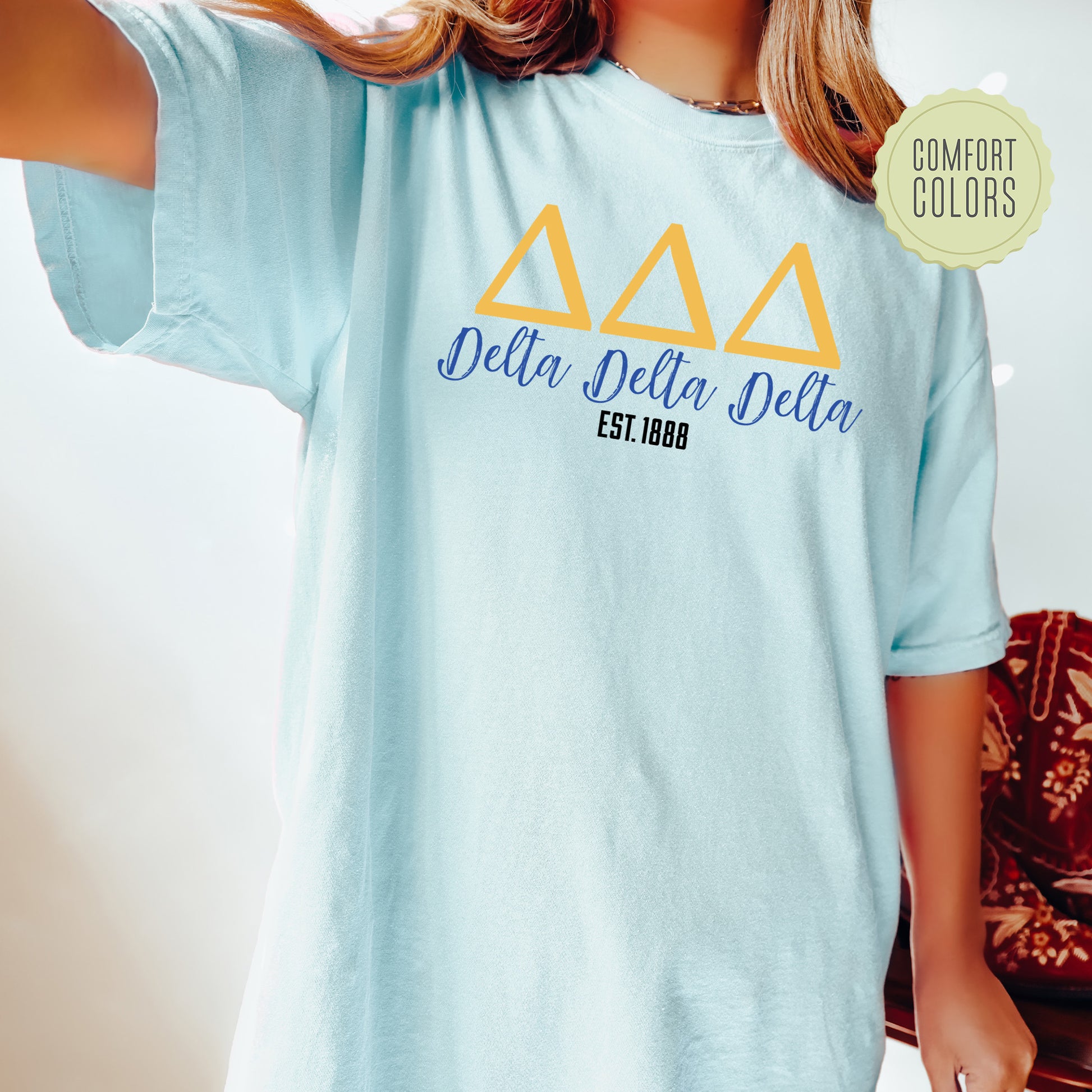 a woman wearing a blue delta delta t - shirt