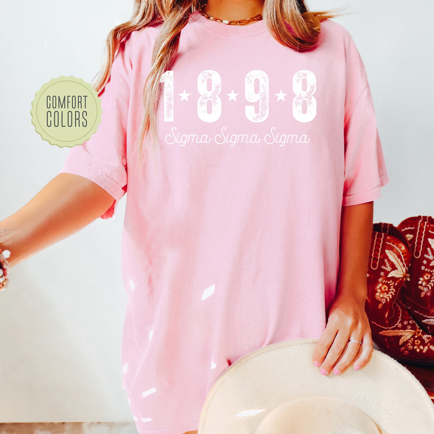 a woman wearing a pink shirt and hat
