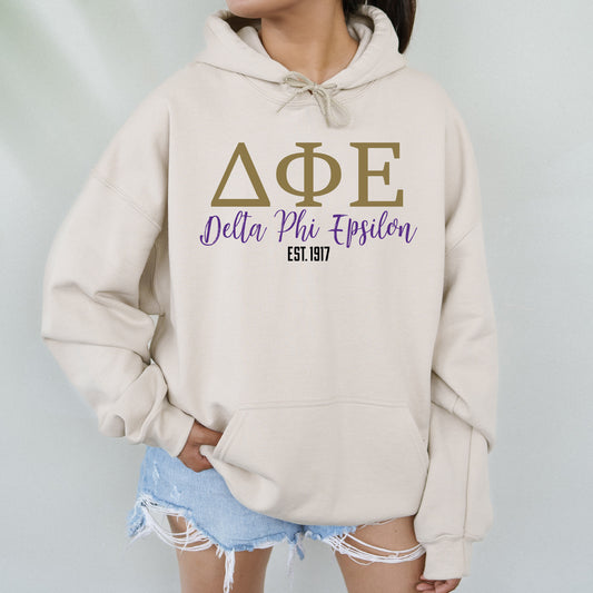 a woman wearing a hoodie that says delta phi phi