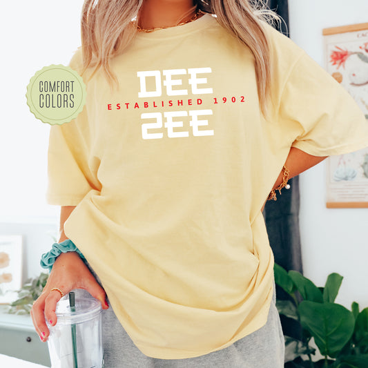 a woman in a yellow shirt holding a blender