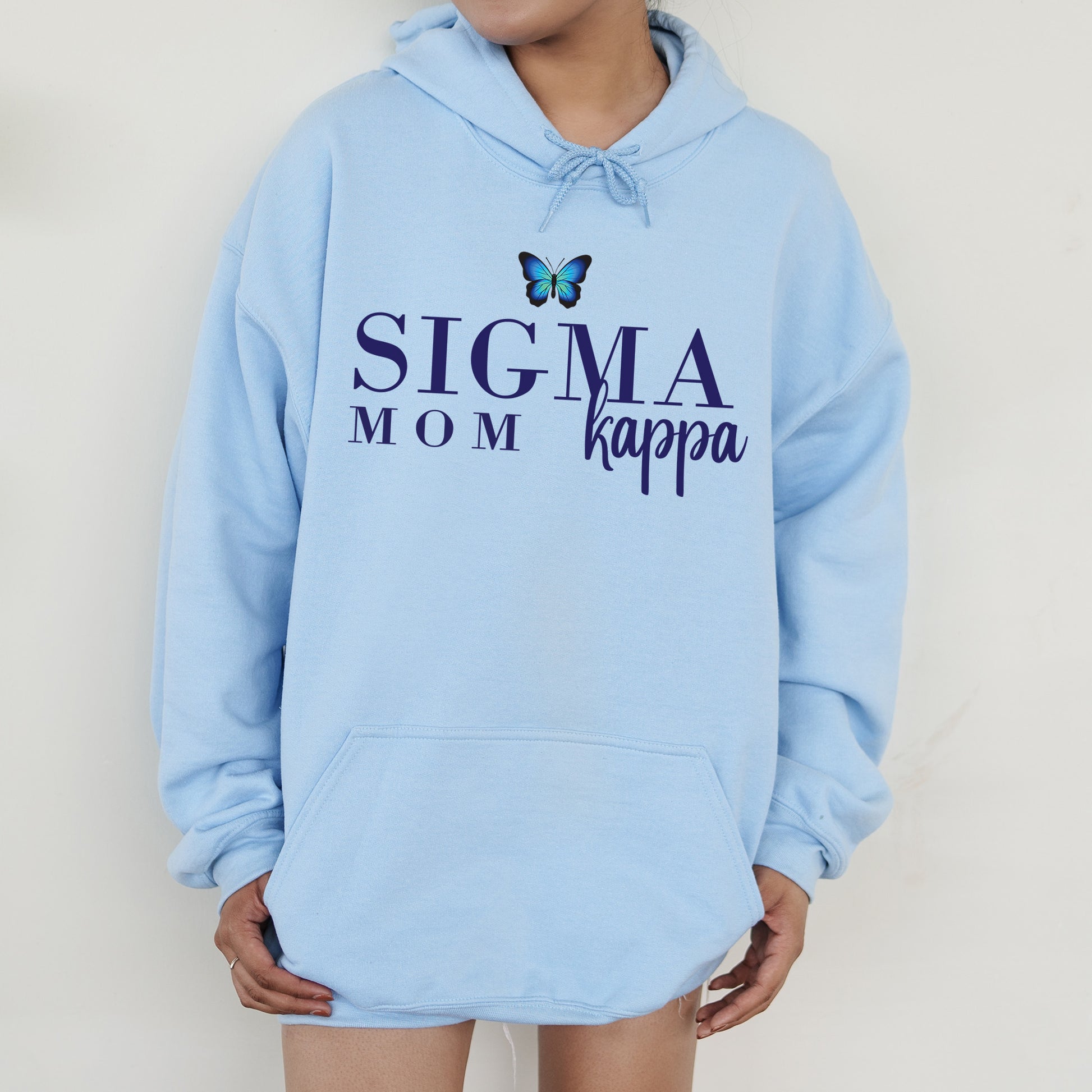 a woman wearing a blue sweatshirt with a butterfly on it