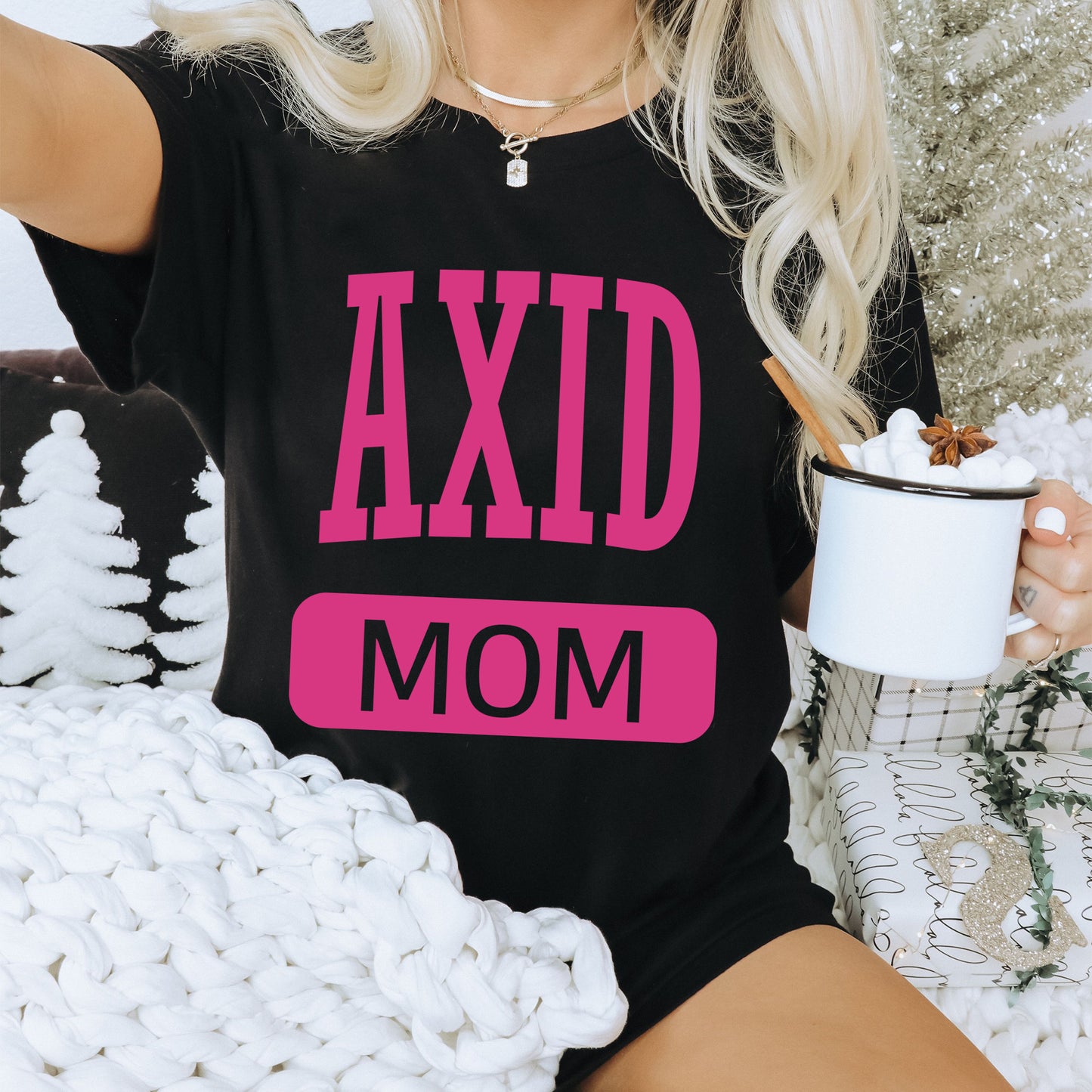 a woman sitting on a couch holding a cup of coffee