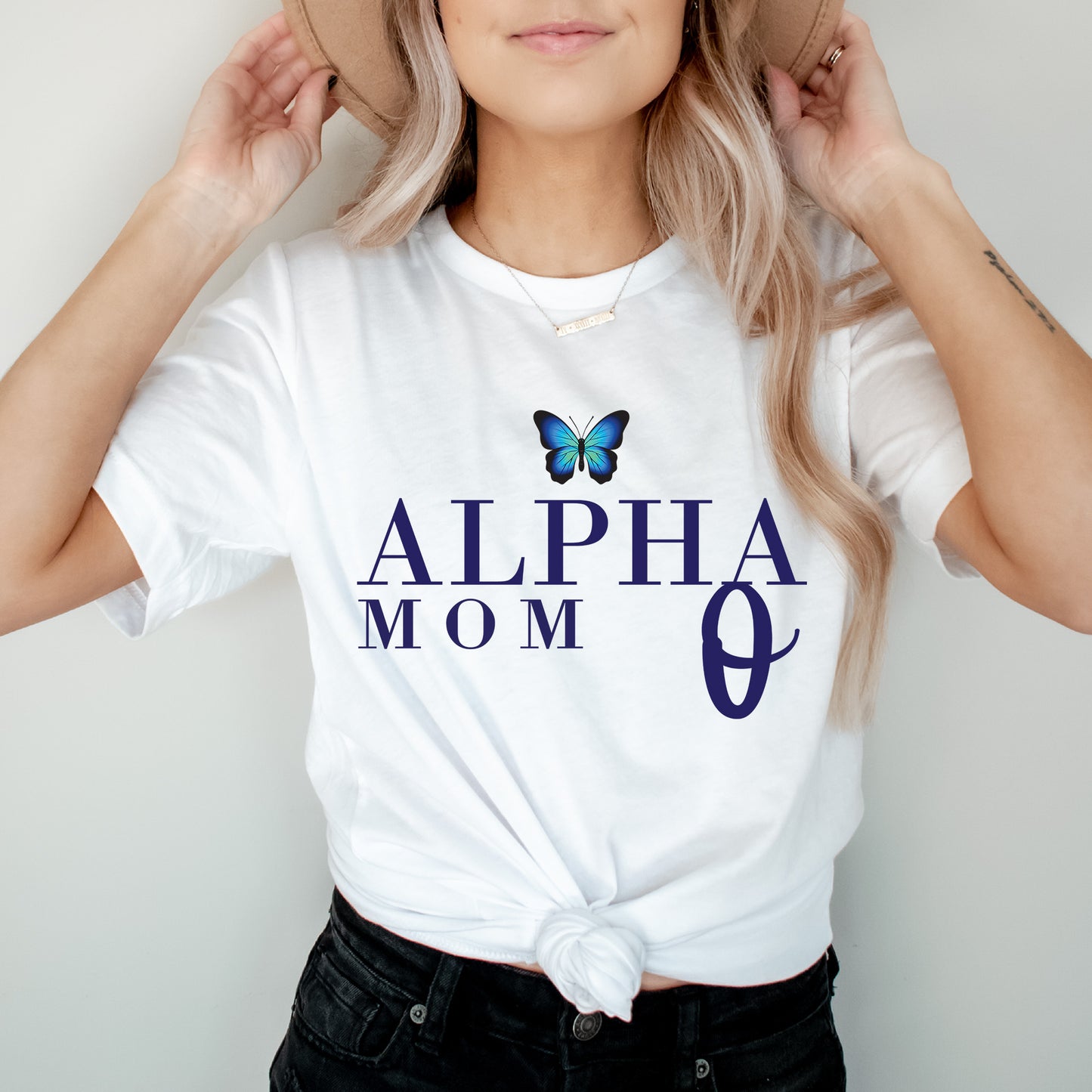 a woman wearing a white shirt with a butterfly on it