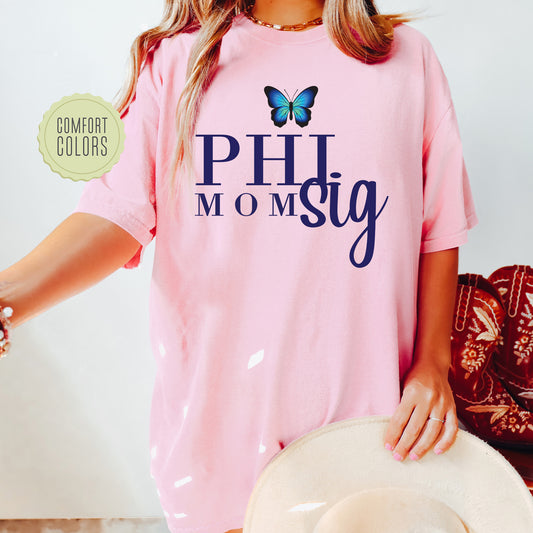 a woman wearing a pink shirt with a butterfly on it