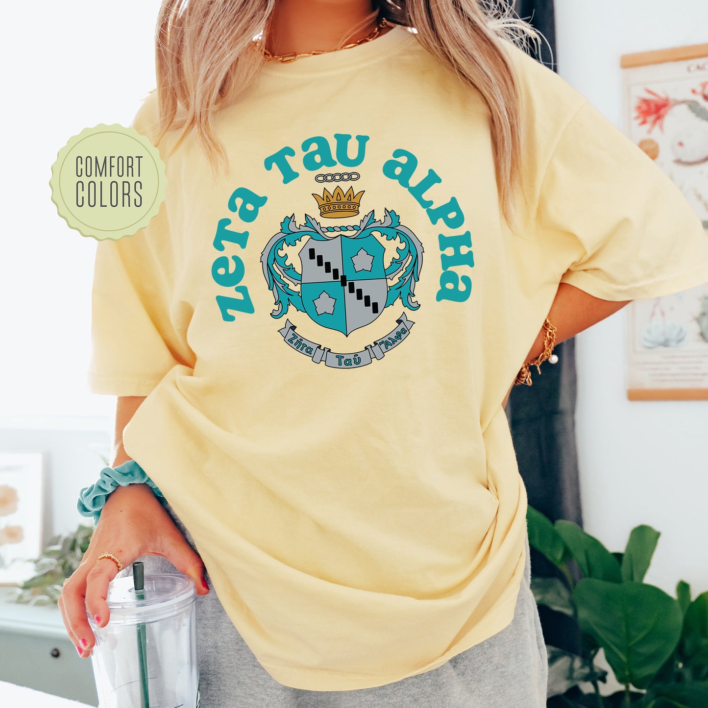 a woman wearing a yellow tshirt with a blue logo on it
