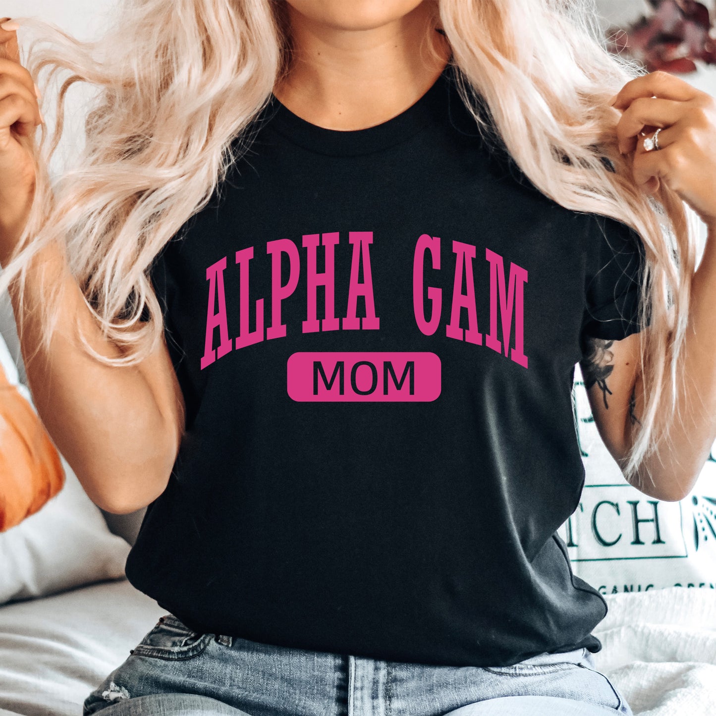 a woman wearing a black shirt with pink letters on it