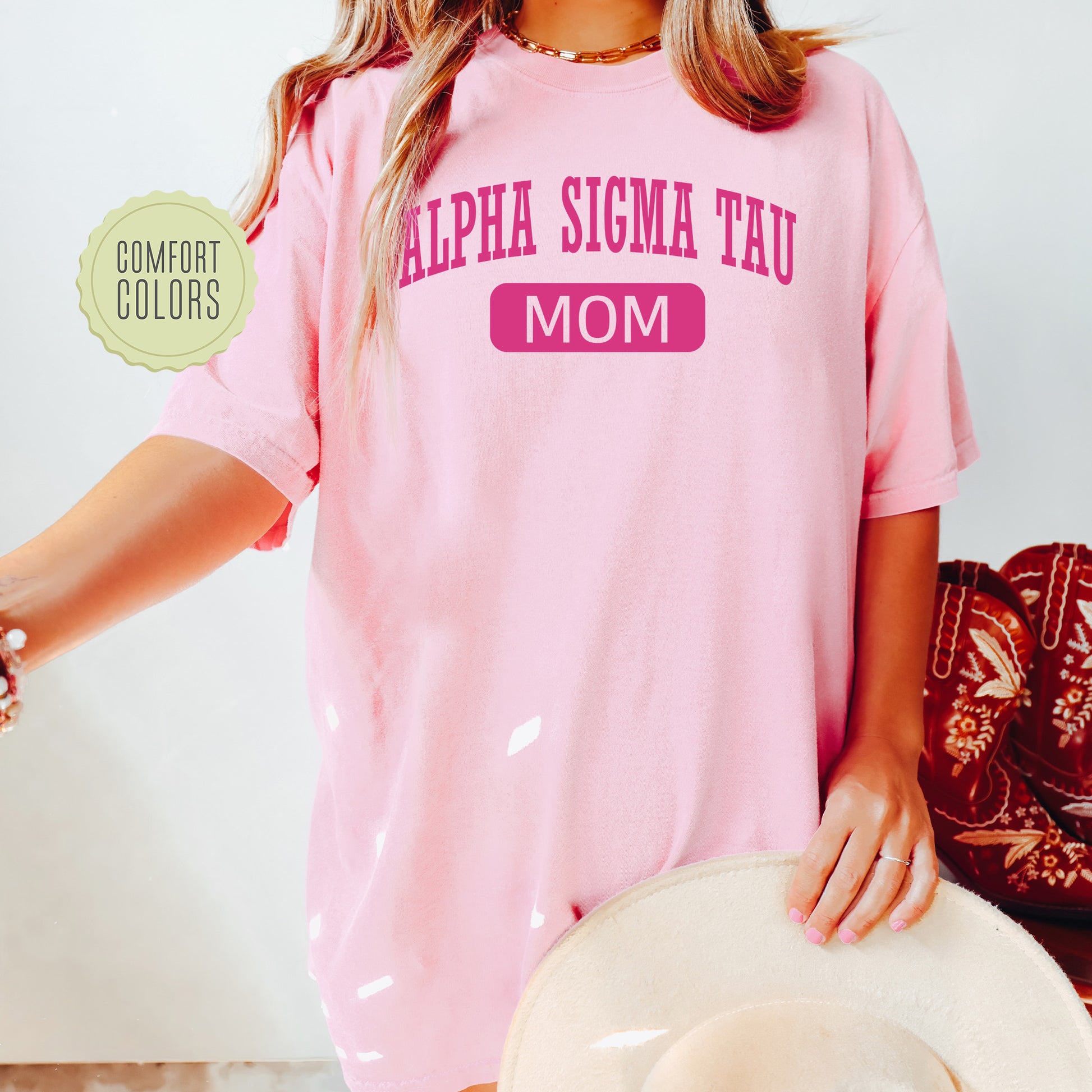 a woman wearing a pink shirt and hat