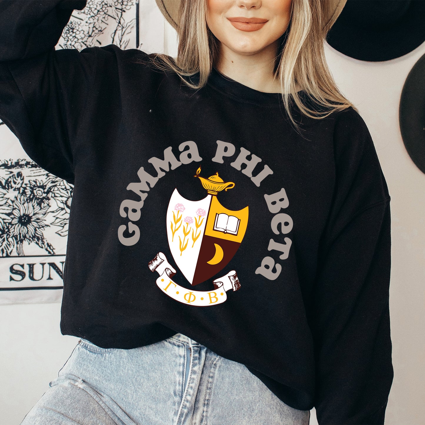 a woman wearing a black sweatshirt and hat