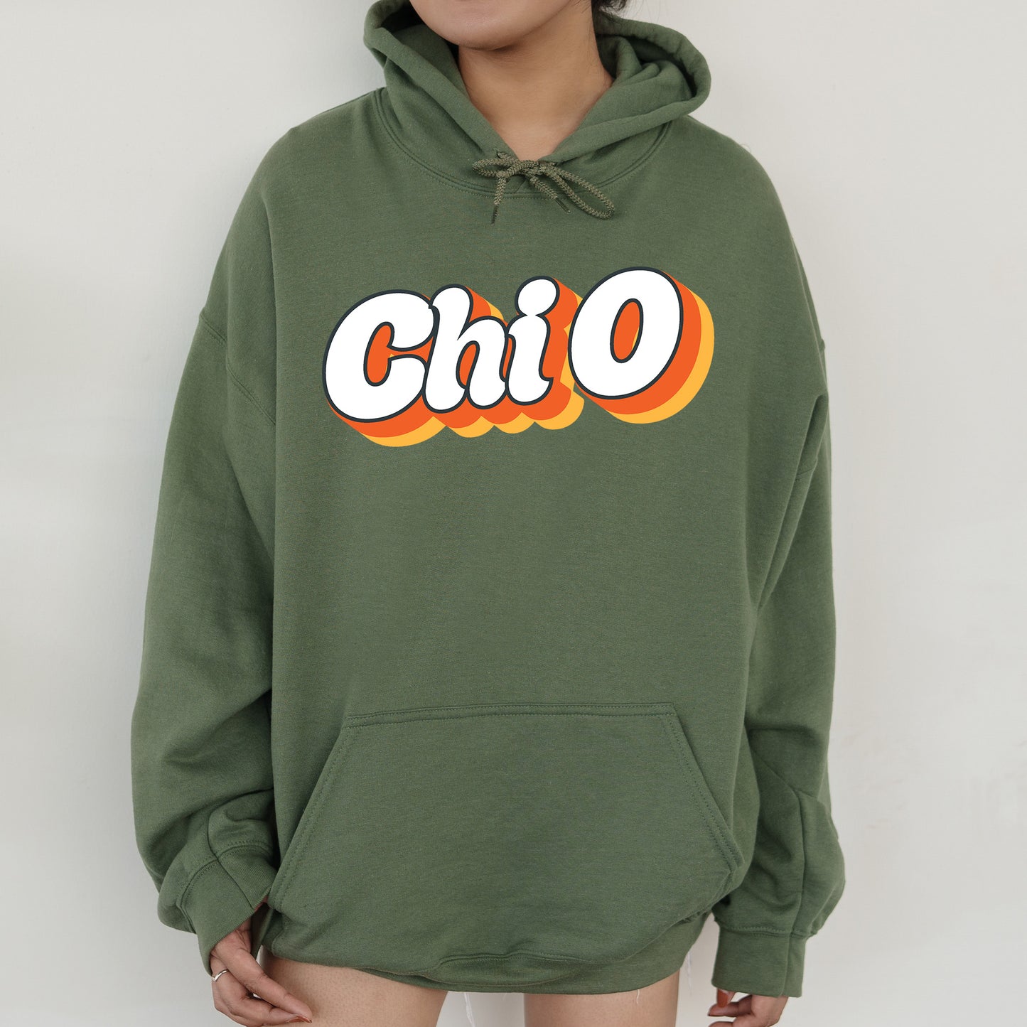 a woman wearing a green hoodie with the word chio printed on it
