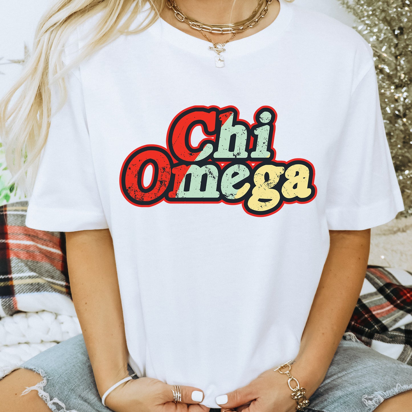 a woman wearing a white shirt with the word chi omega printed on it