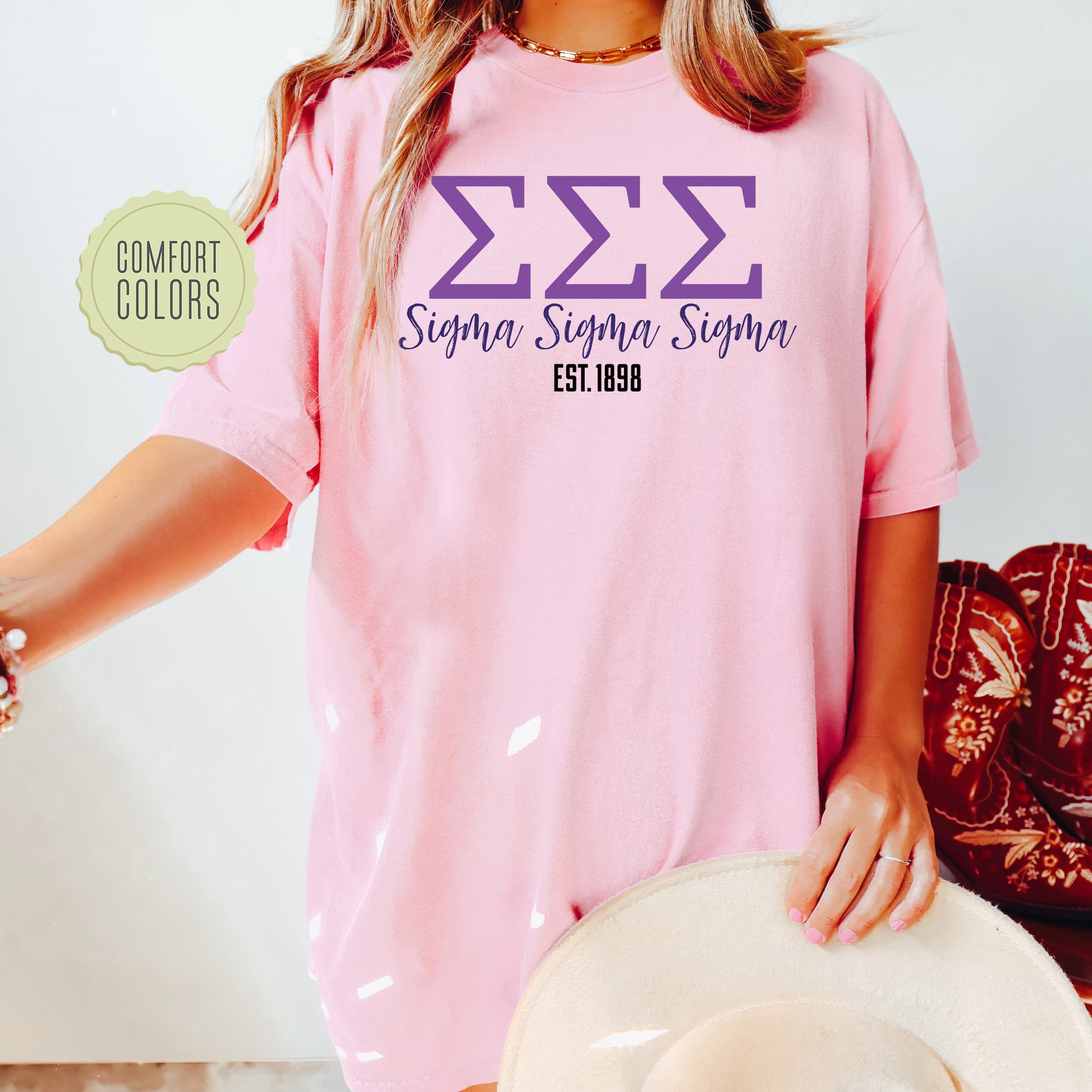 a woman wearing a pink shirt and hat