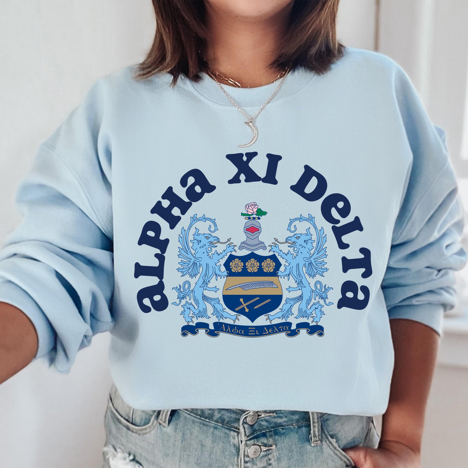 a woman wearing a blue sweatshirt with a crest on it