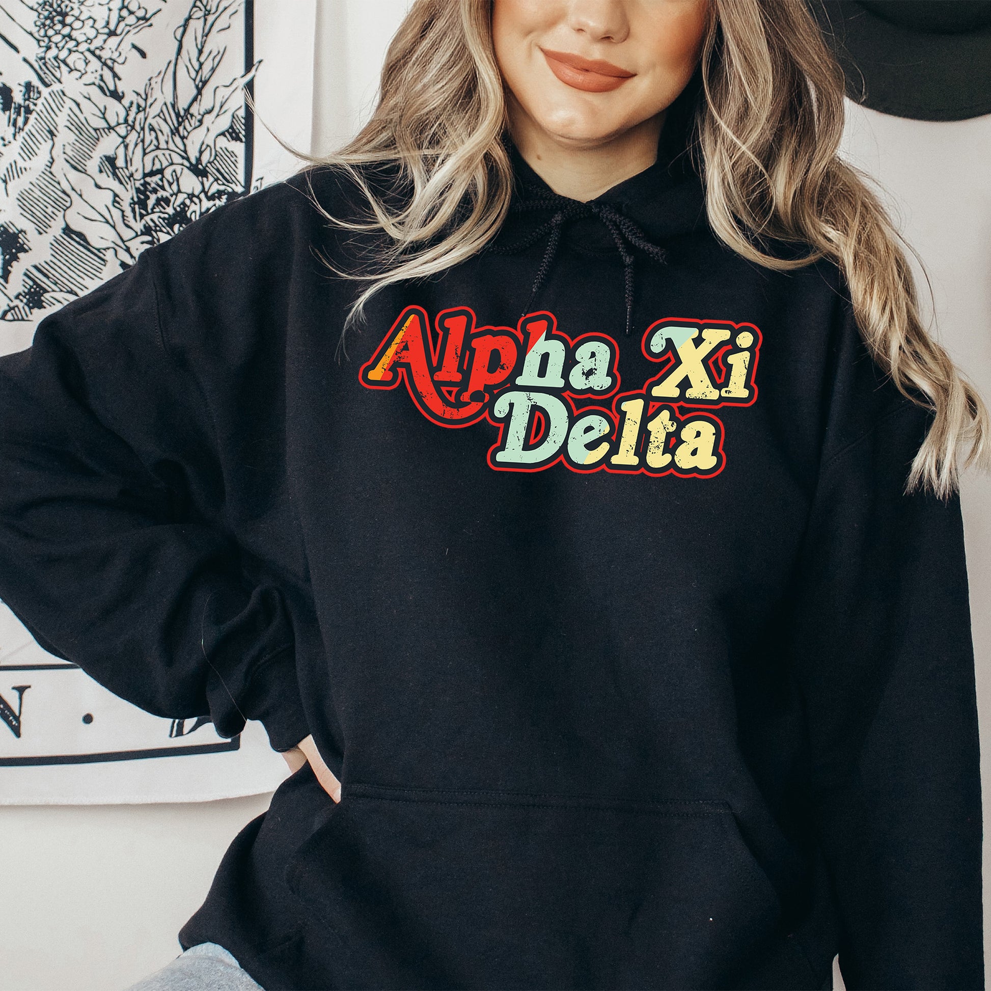 a woman wearing a black hoodie with the word aha delta on it