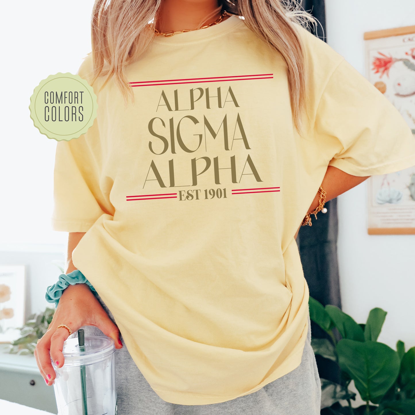 a woman in a yellow shirt holding a drink