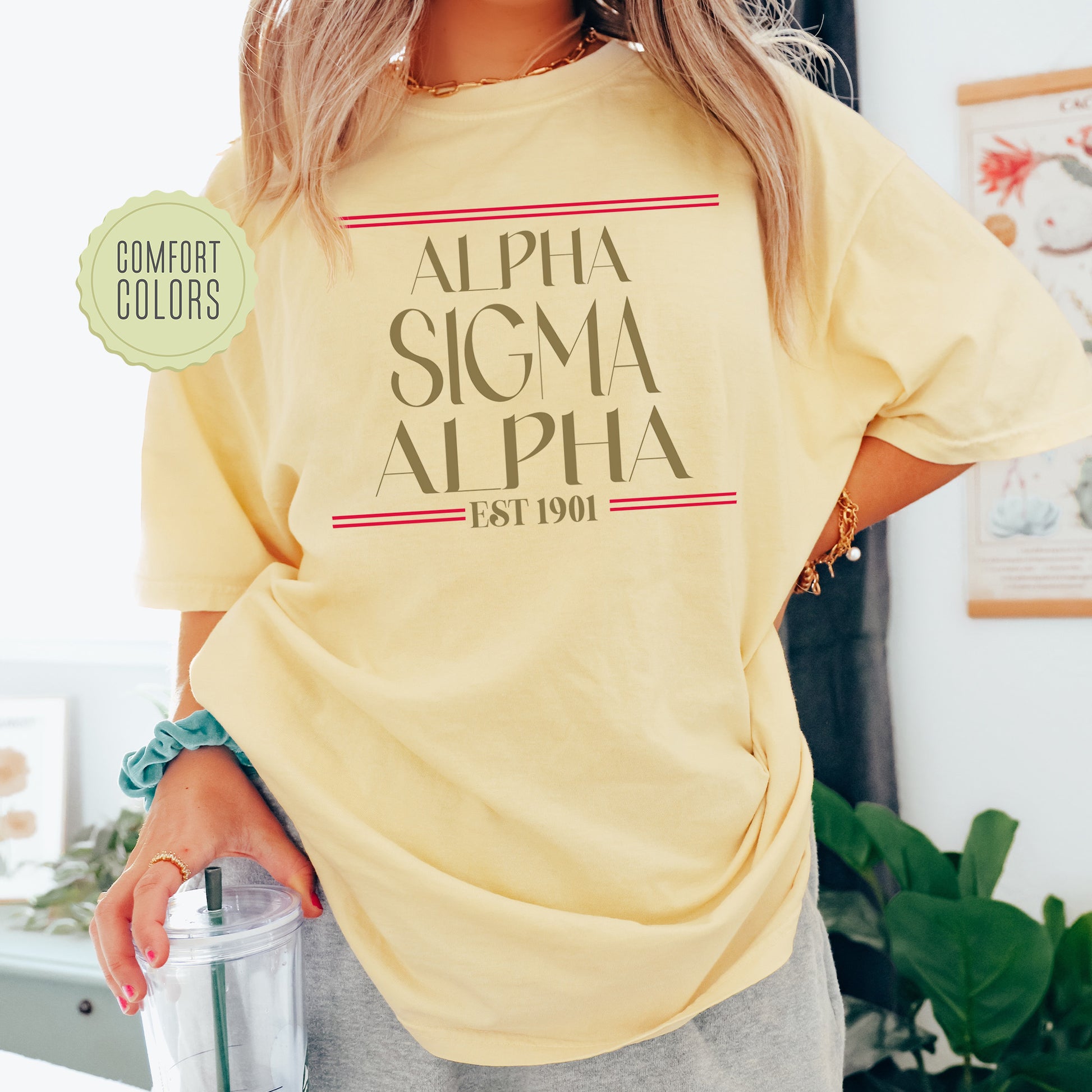a woman in a yellow shirt holding a drink