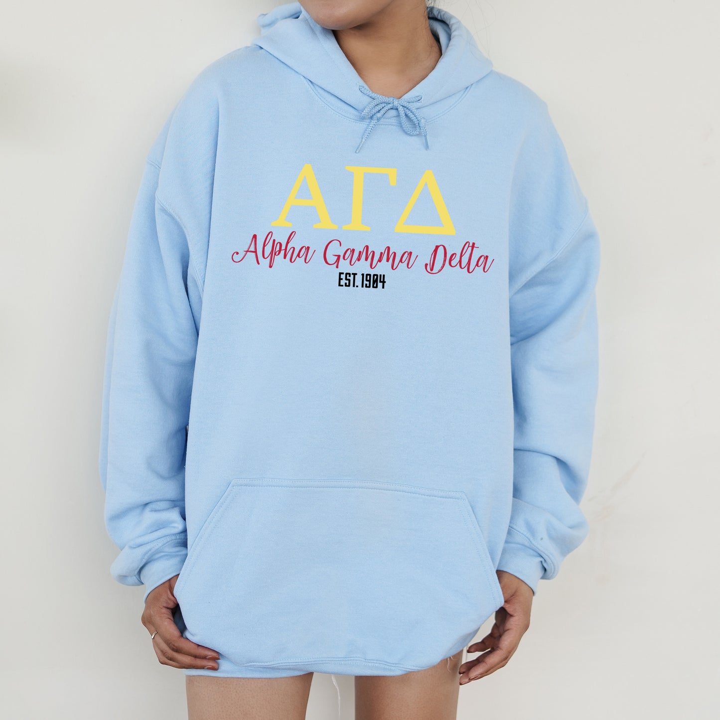 a person wearing a blue hoodie with the words atta on it