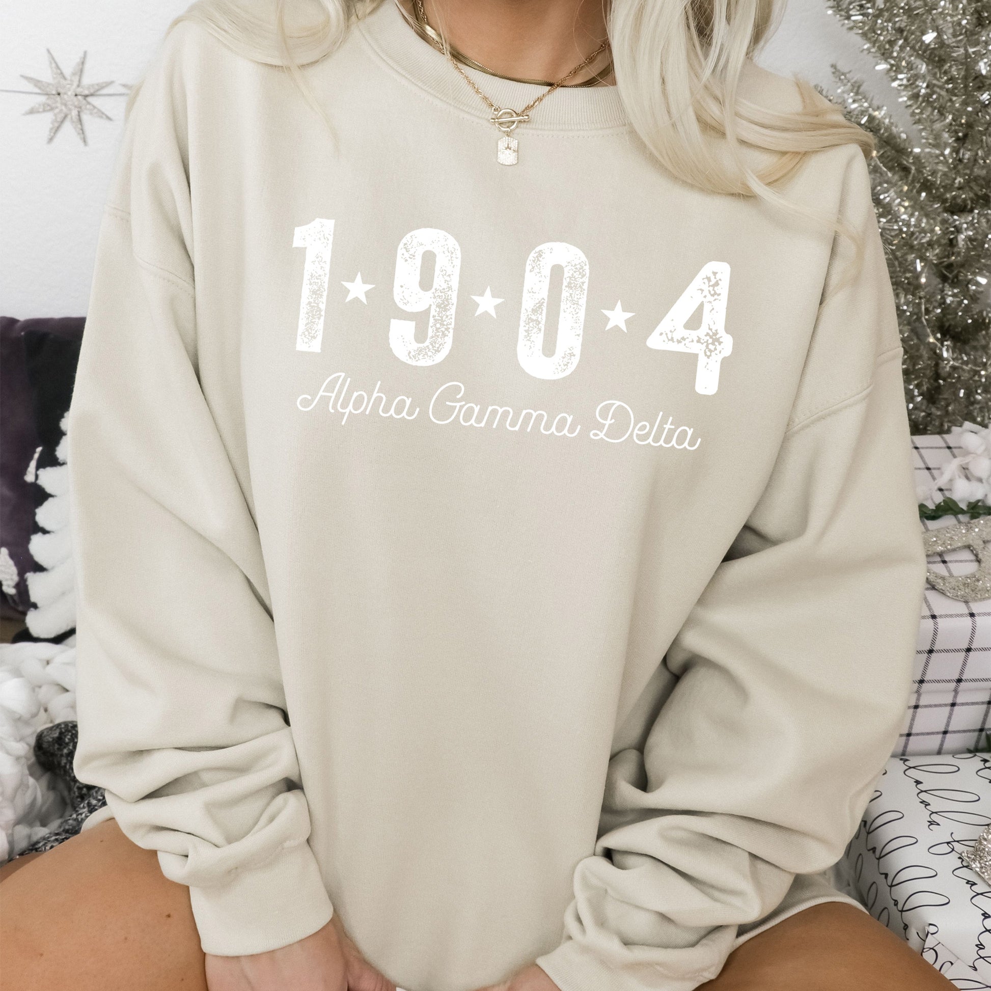 a woman sitting on a couch wearing a sweatshirt