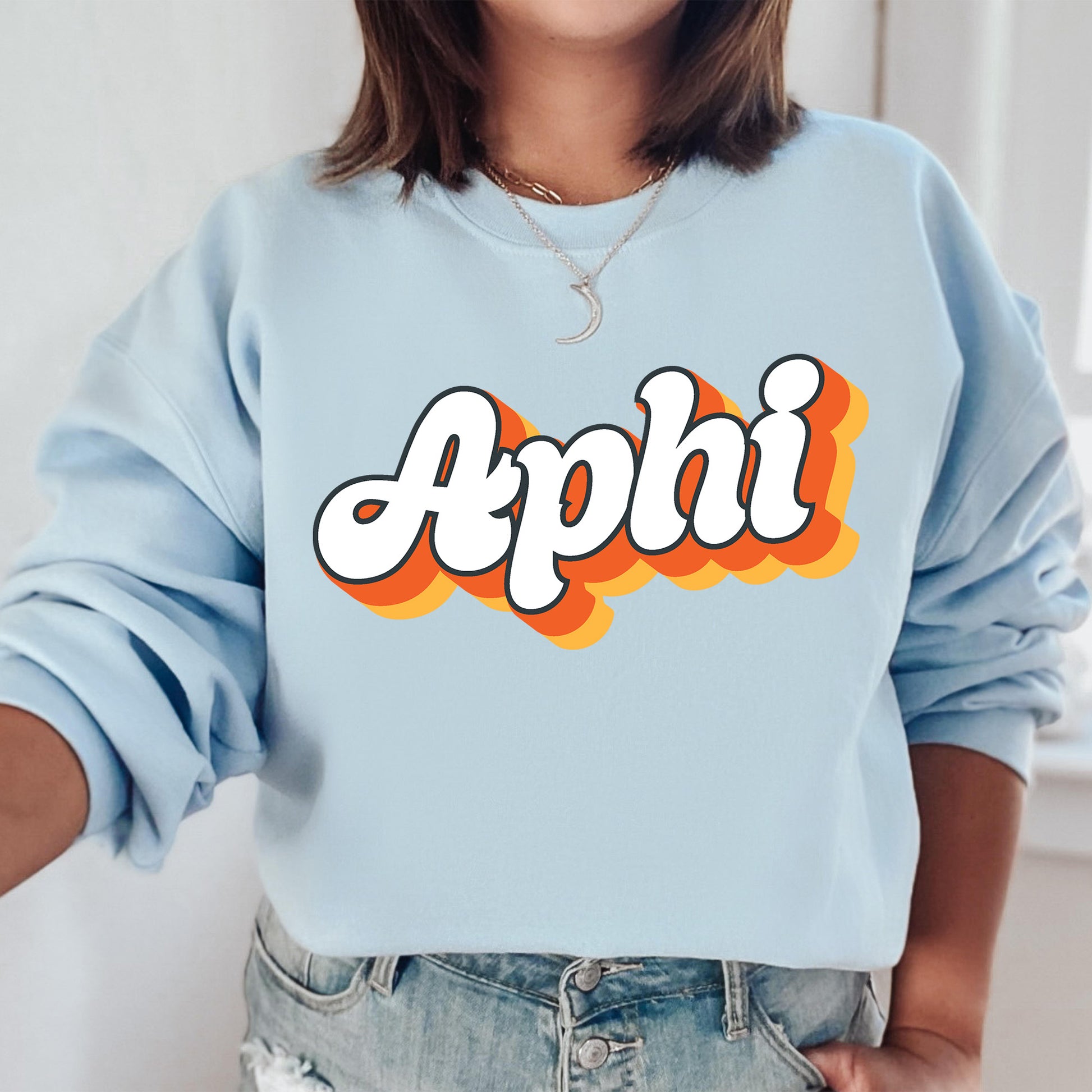 a woman wearing a blue sweatshirt with the word apphi printed on it