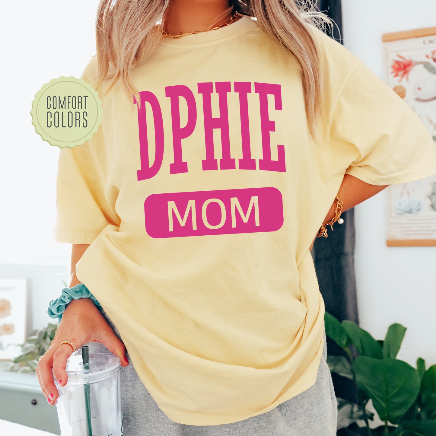 a woman in a yellow shirt holding a blender