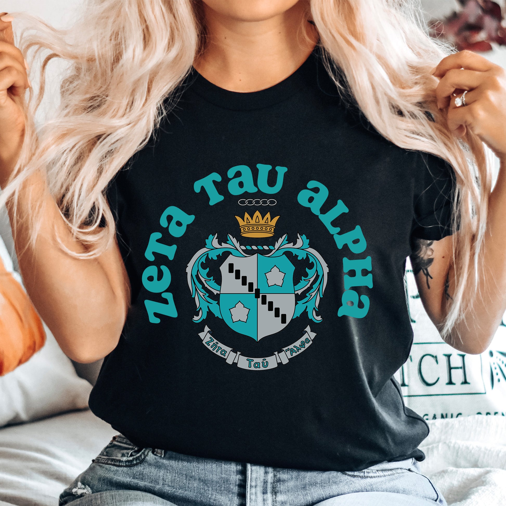 a woman wearing a black t - shirt with a crown on it