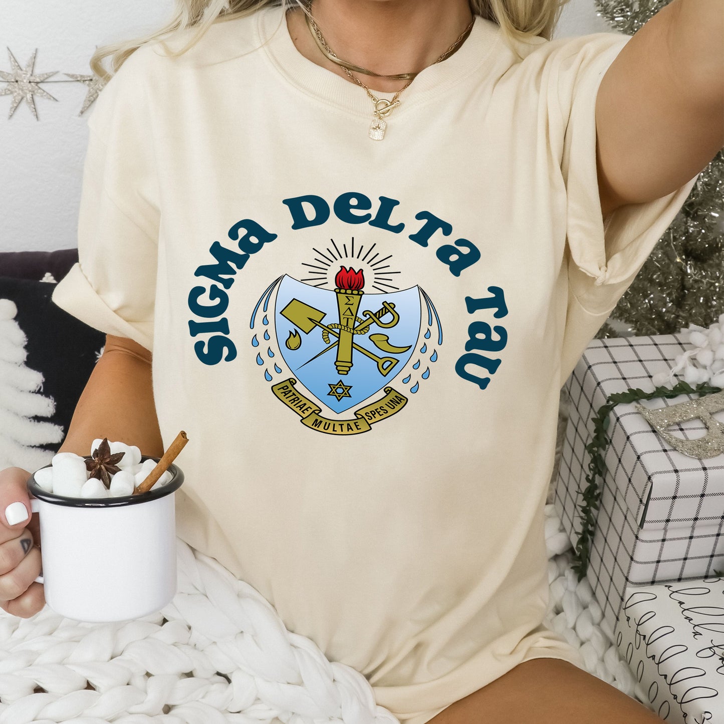 a woman sitting on a bed holding a cup of coffee