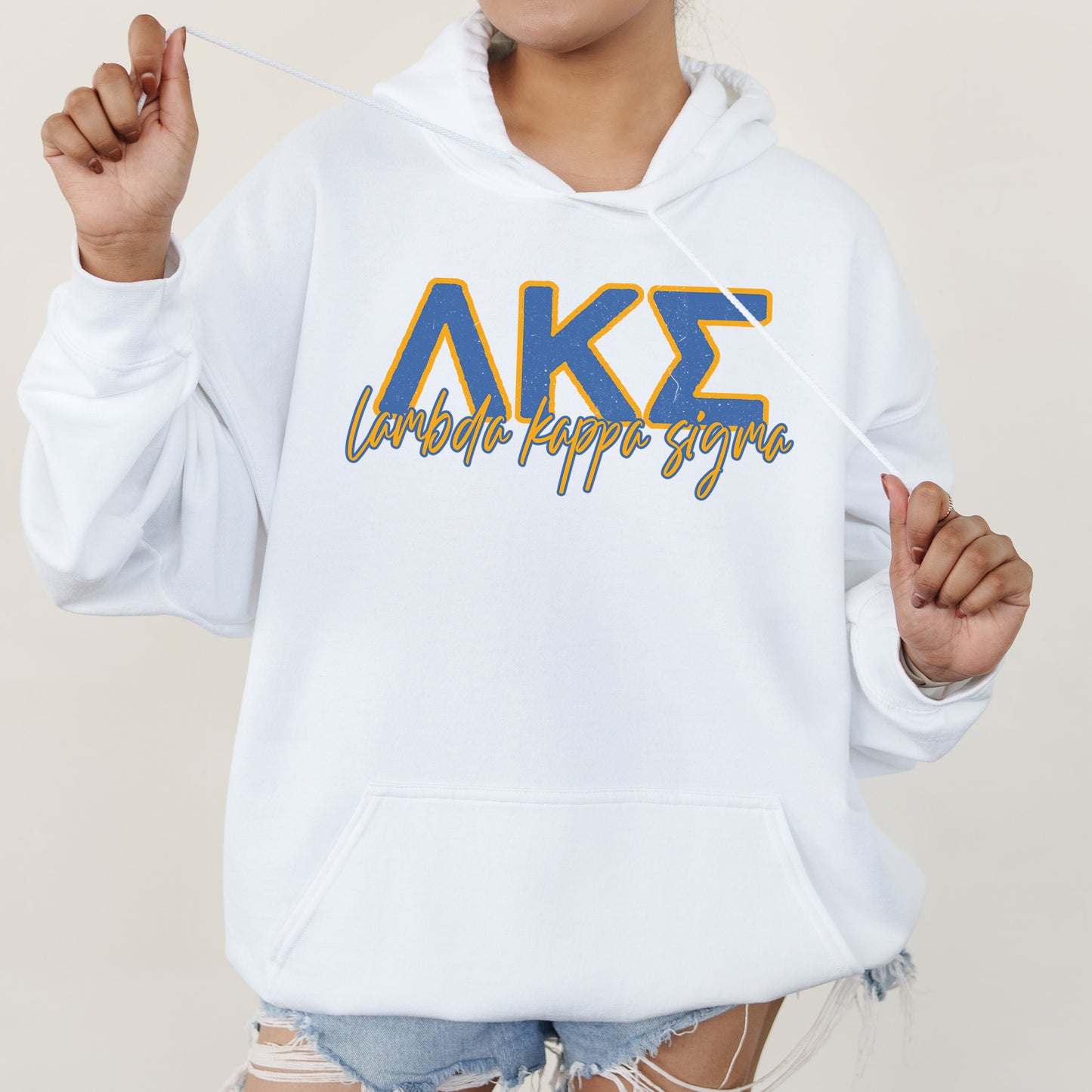 a woman wearing a white hoodie with the letters ake on it