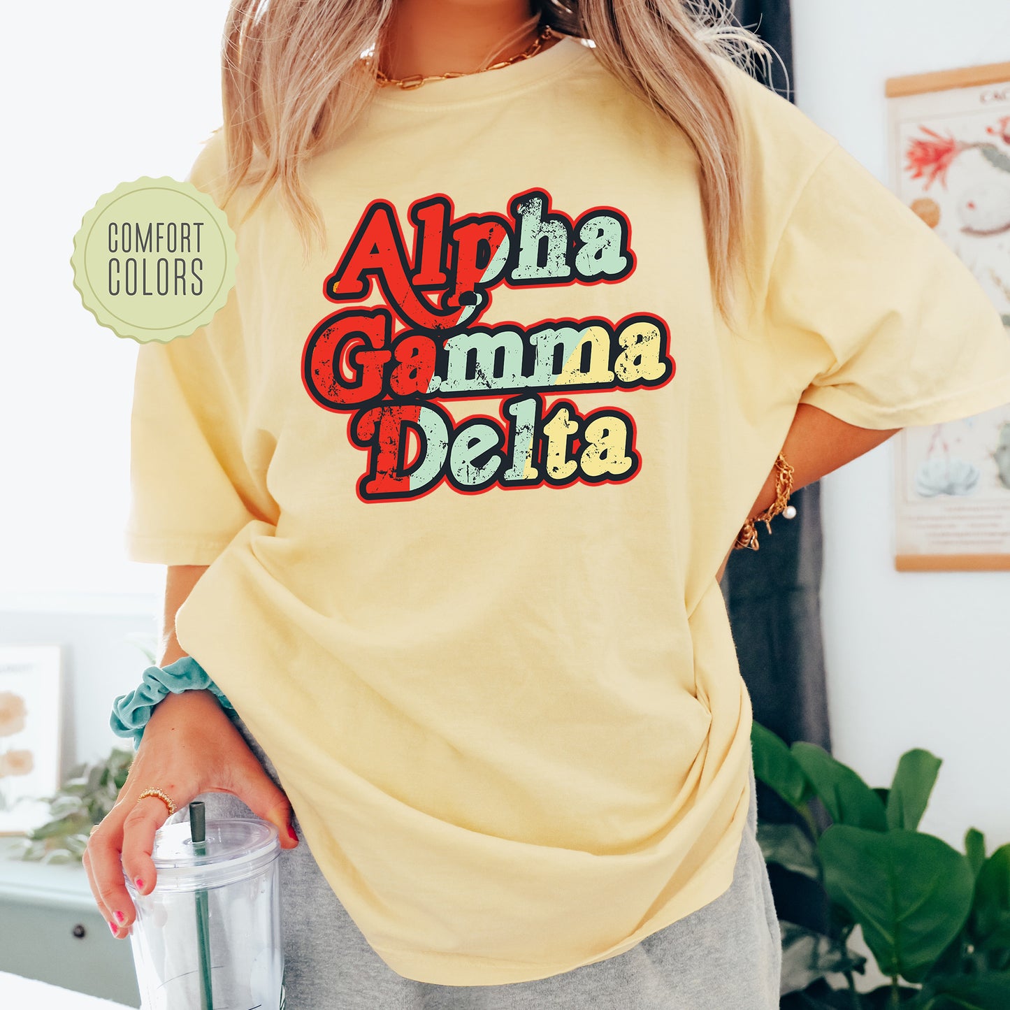 a woman wearing a yellow shirt with the words aha gama delta on it
