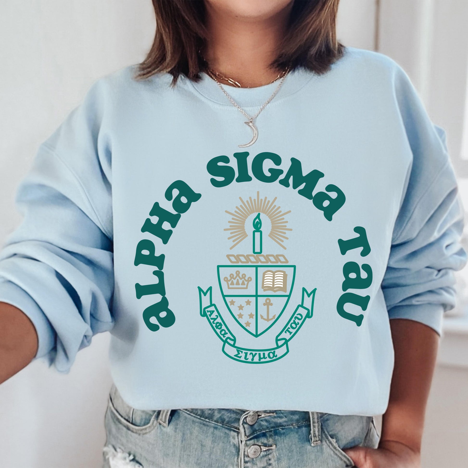 a woman wearing a blue sweatshirt with a green logo on it