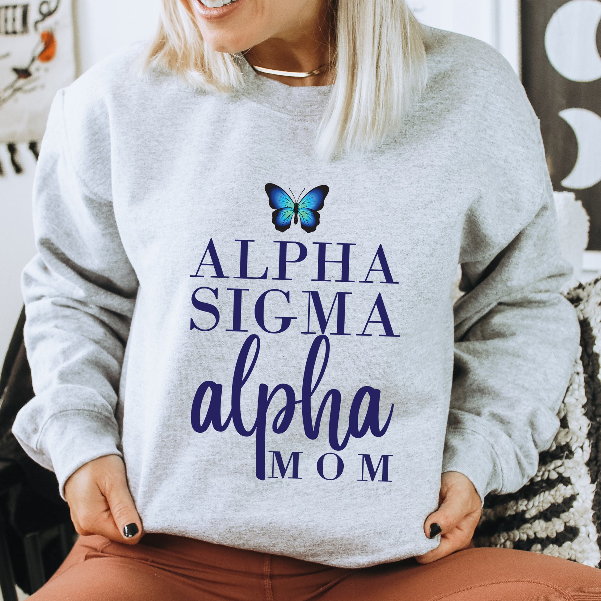 a woman wearing a sweatshirt with a butterfly on it