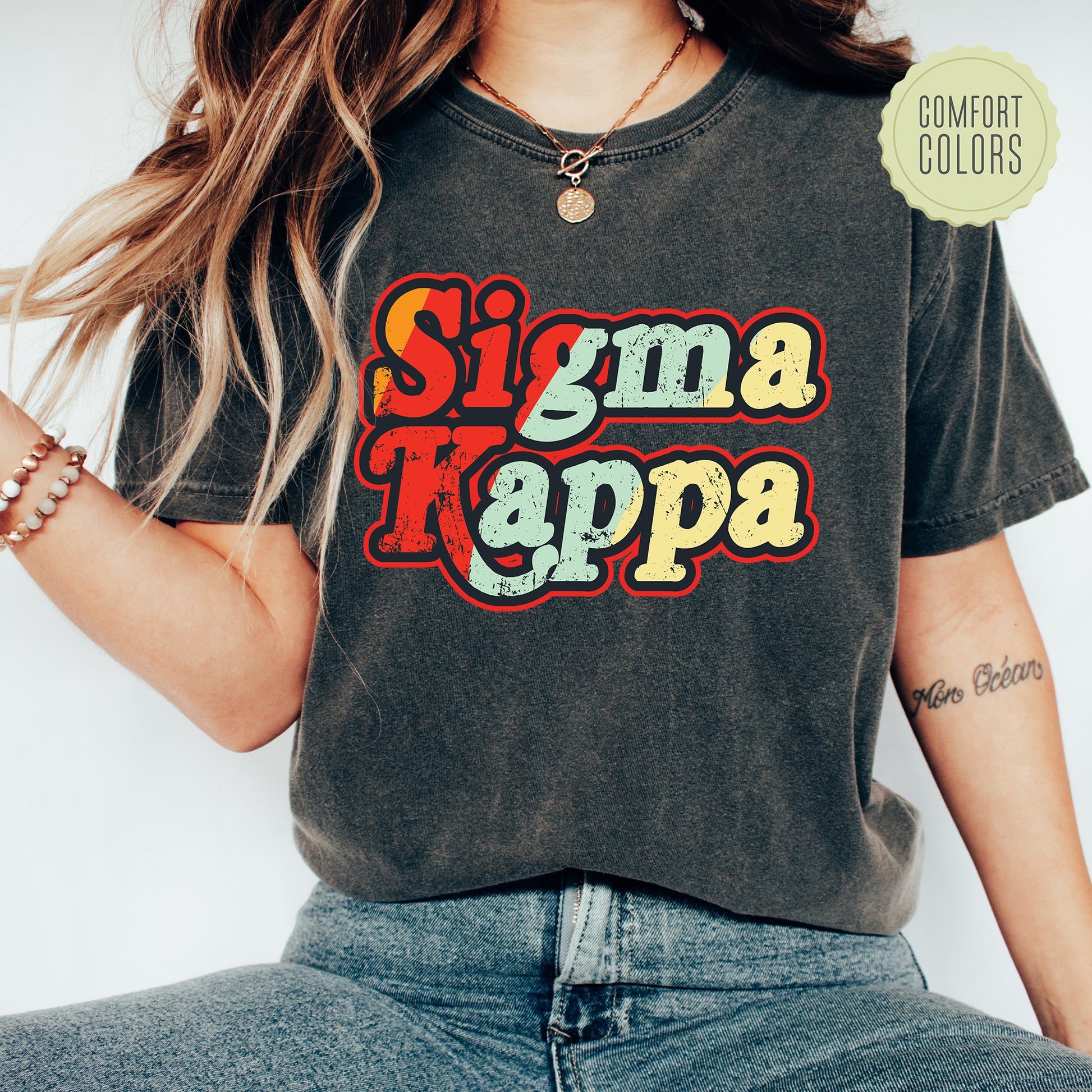 a woman wearing a shirt that says stigma kappa