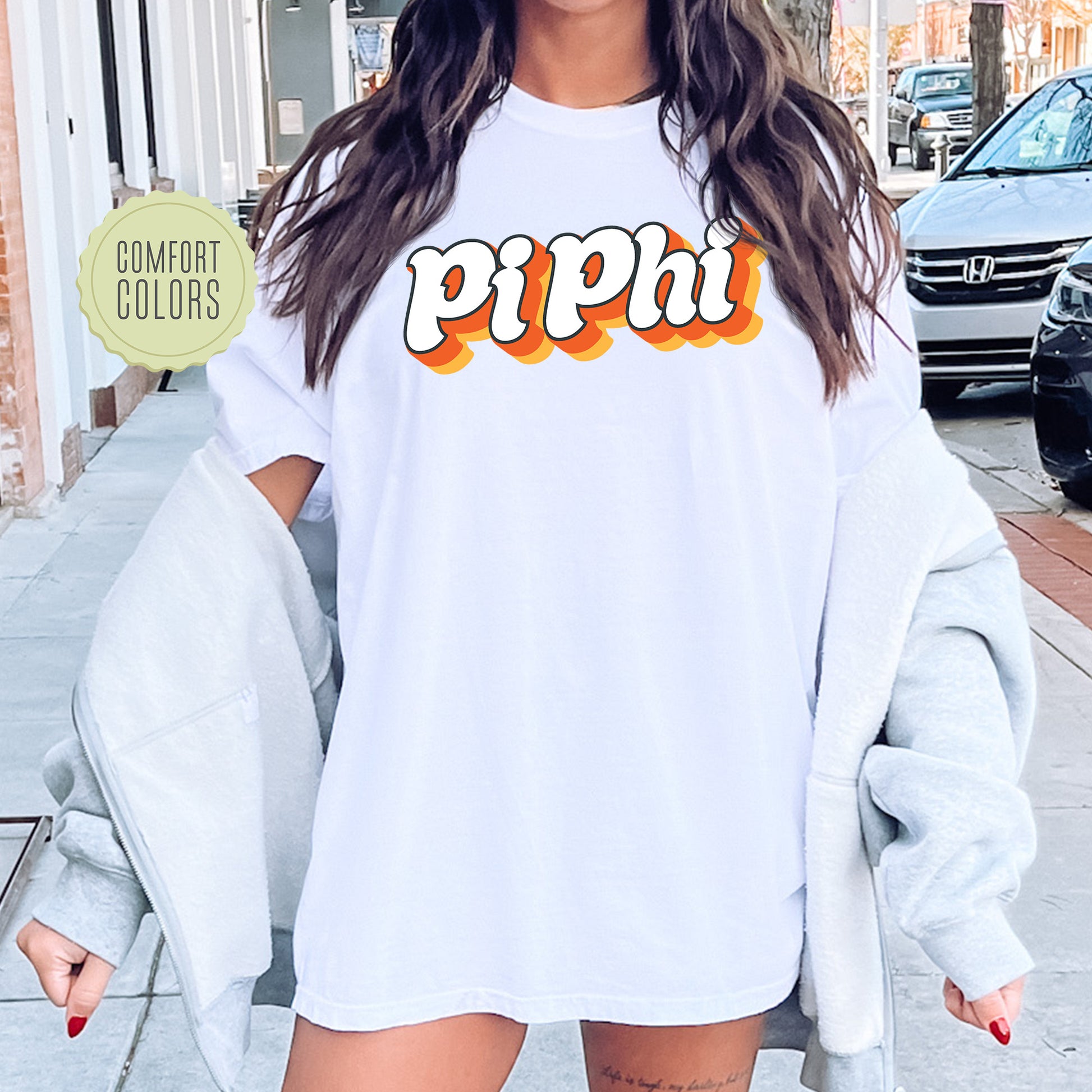 a woman wearing a white shirt with the word peppi on it