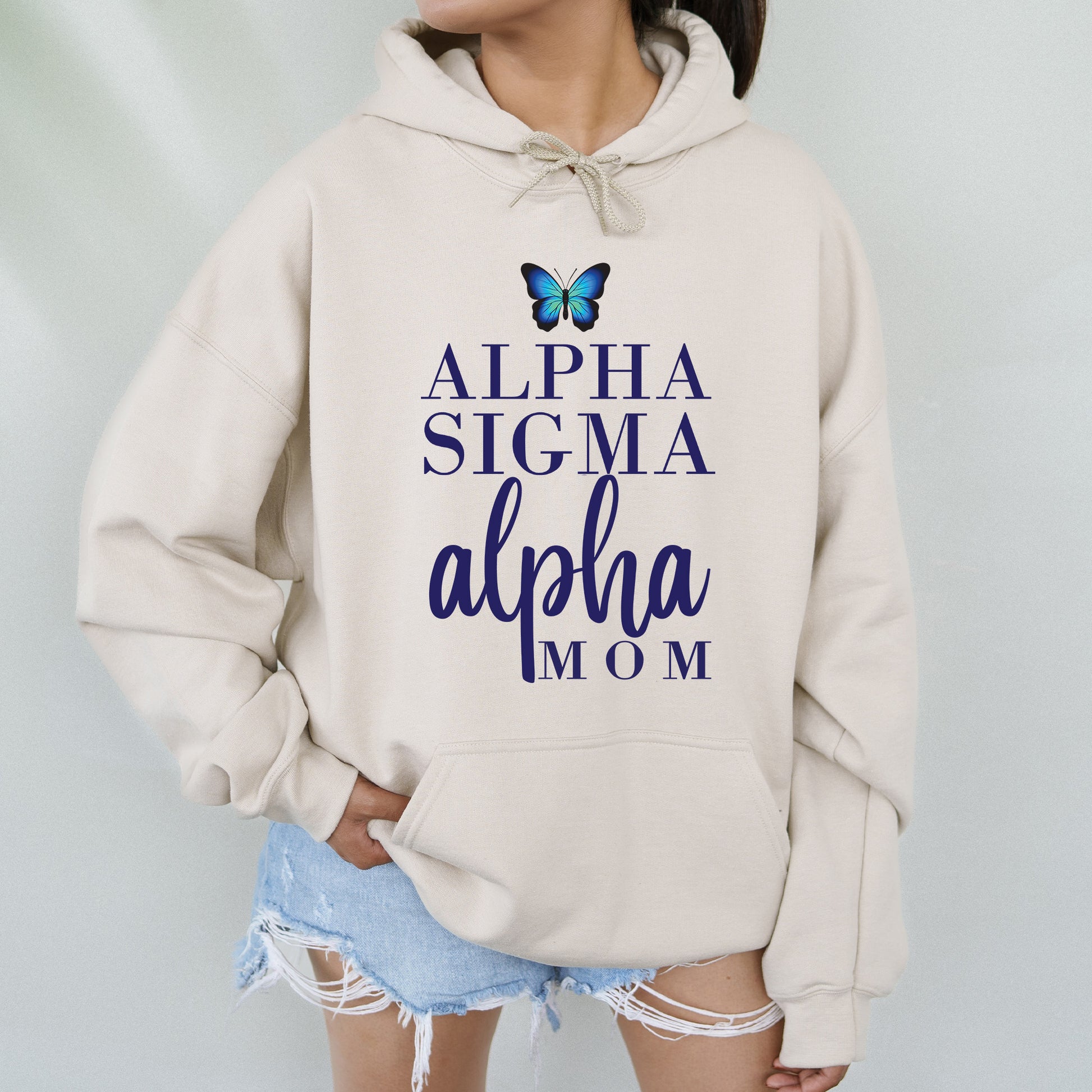 a woman wearing a sweatshirt with the words aloha and a butterfly on it