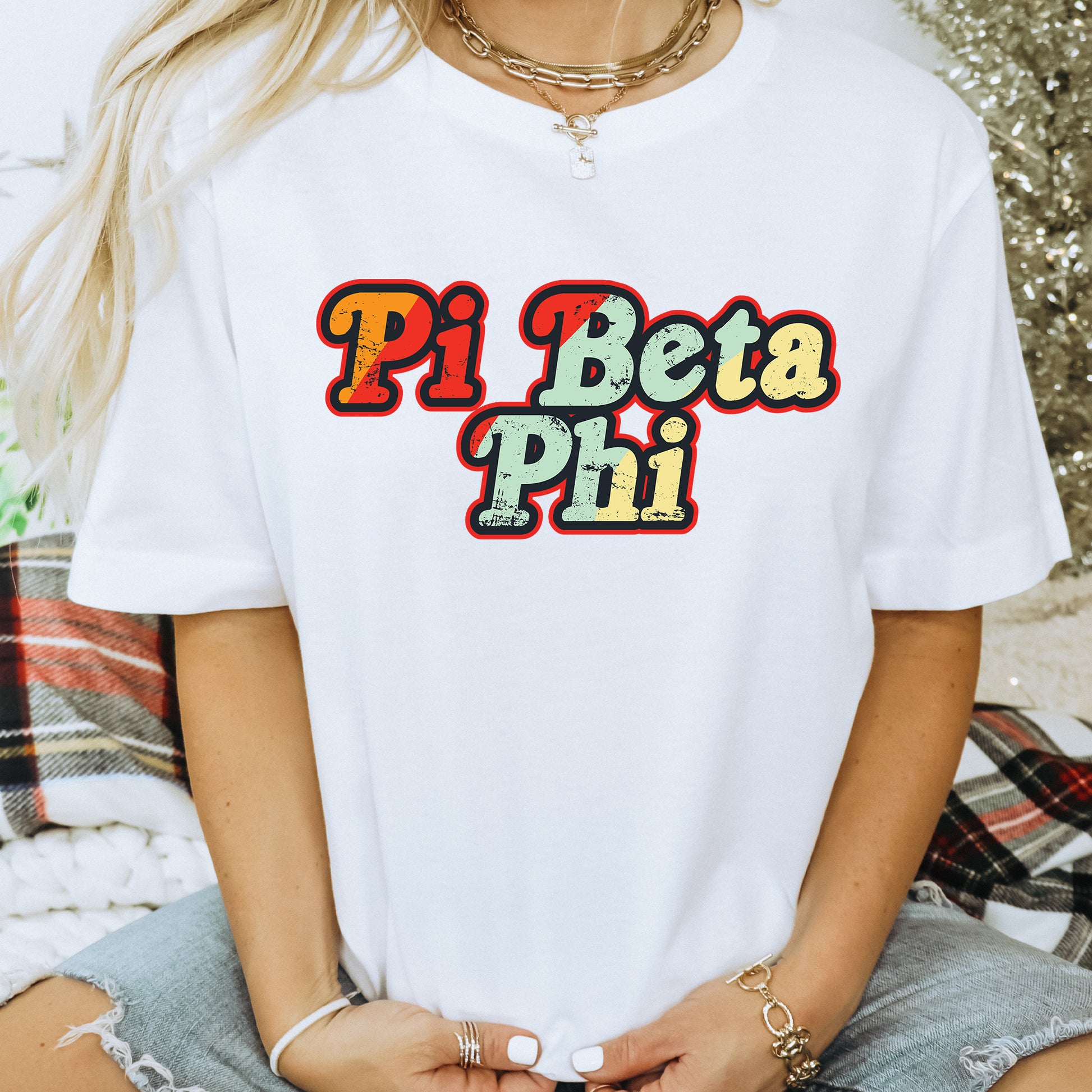 a woman wearing a white t - shirt that says pi beta pi