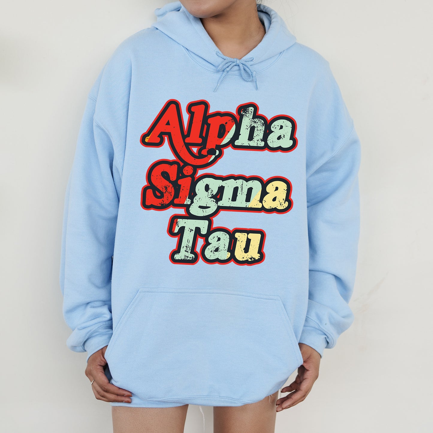 a person wearing a blue hoodie with the words aloha stigma tau