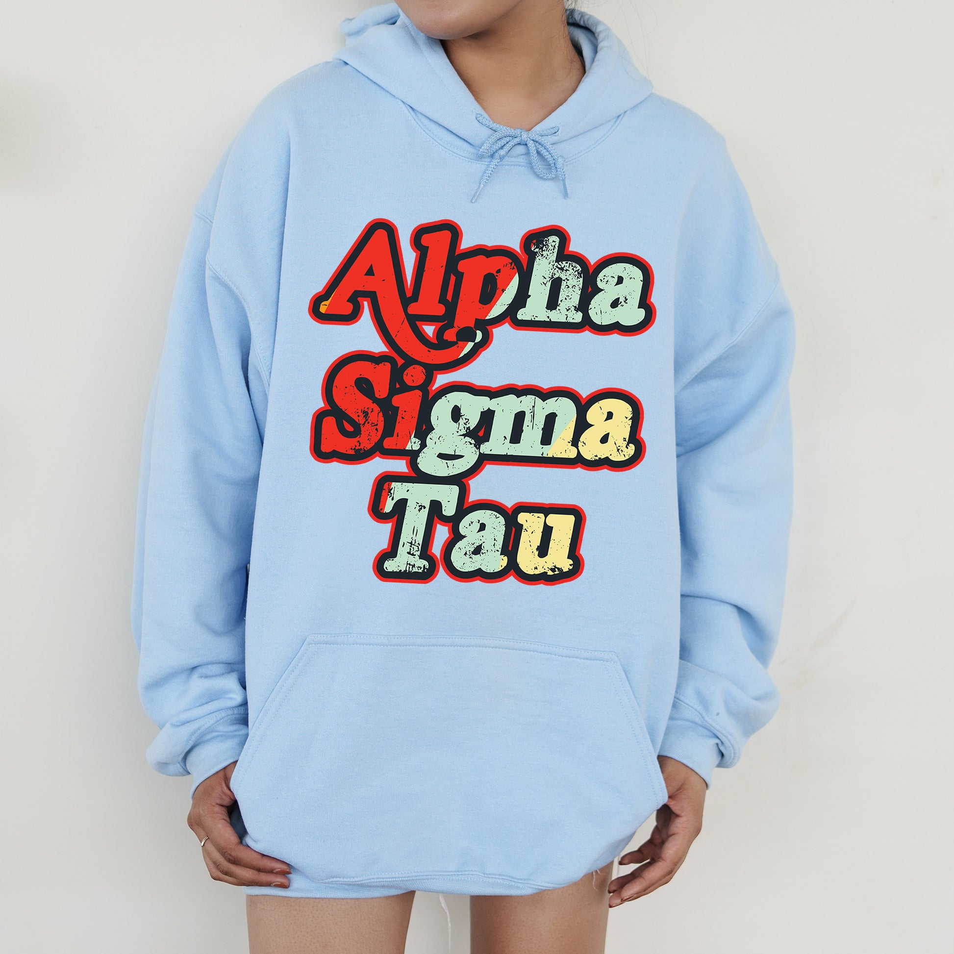 a person wearing a blue hoodie with the words aloha stigma tau