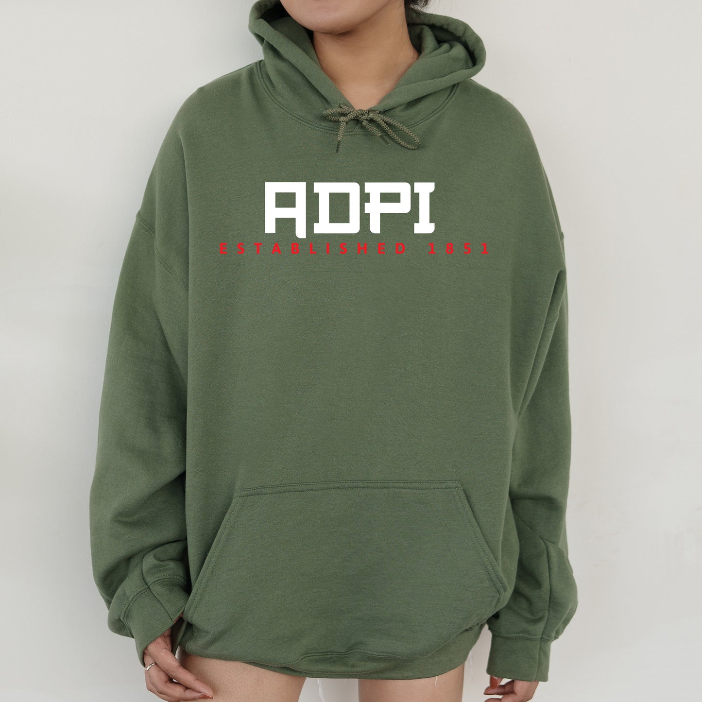 a person wearing a green hoodie with the word aopi printed on it
