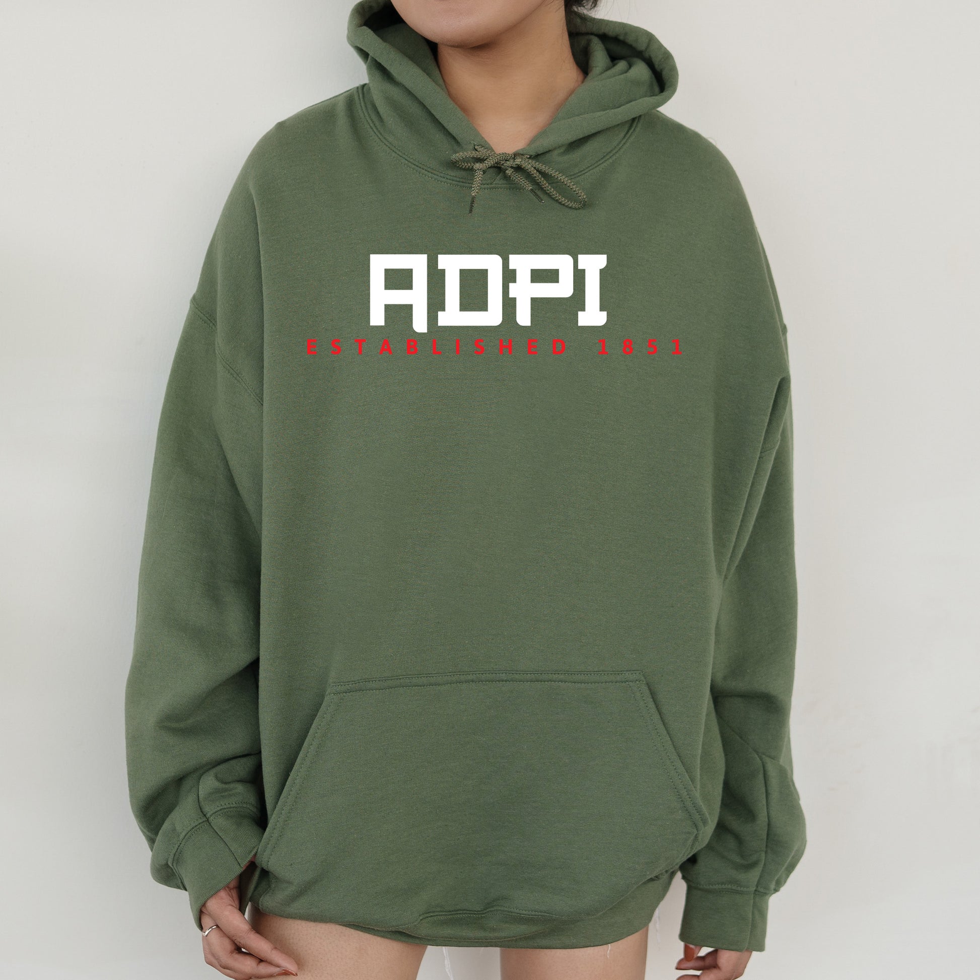 a person wearing a green hoodie with the word aopi printed on it