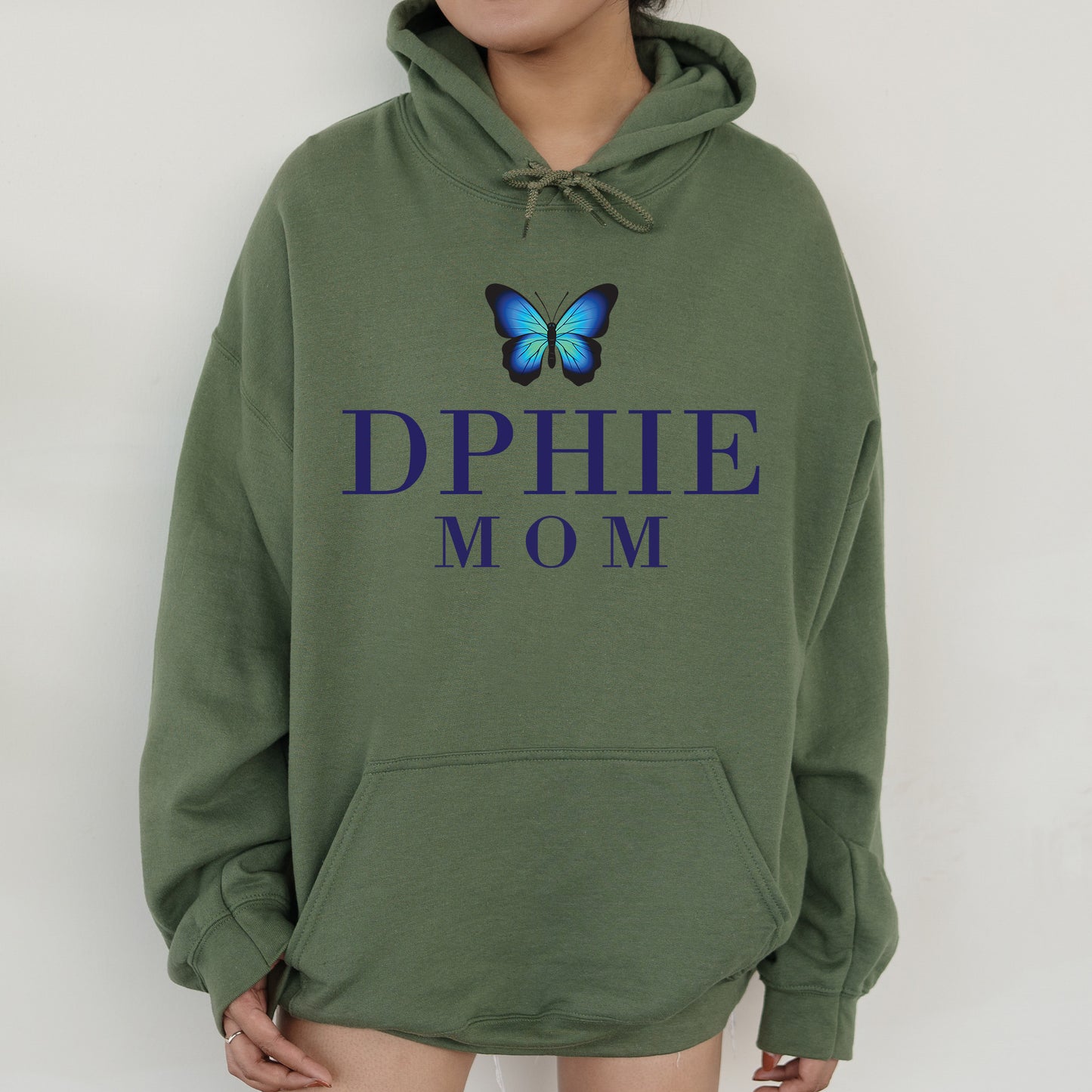 a woman wearing a green hoodie with a blue butterfly on it
