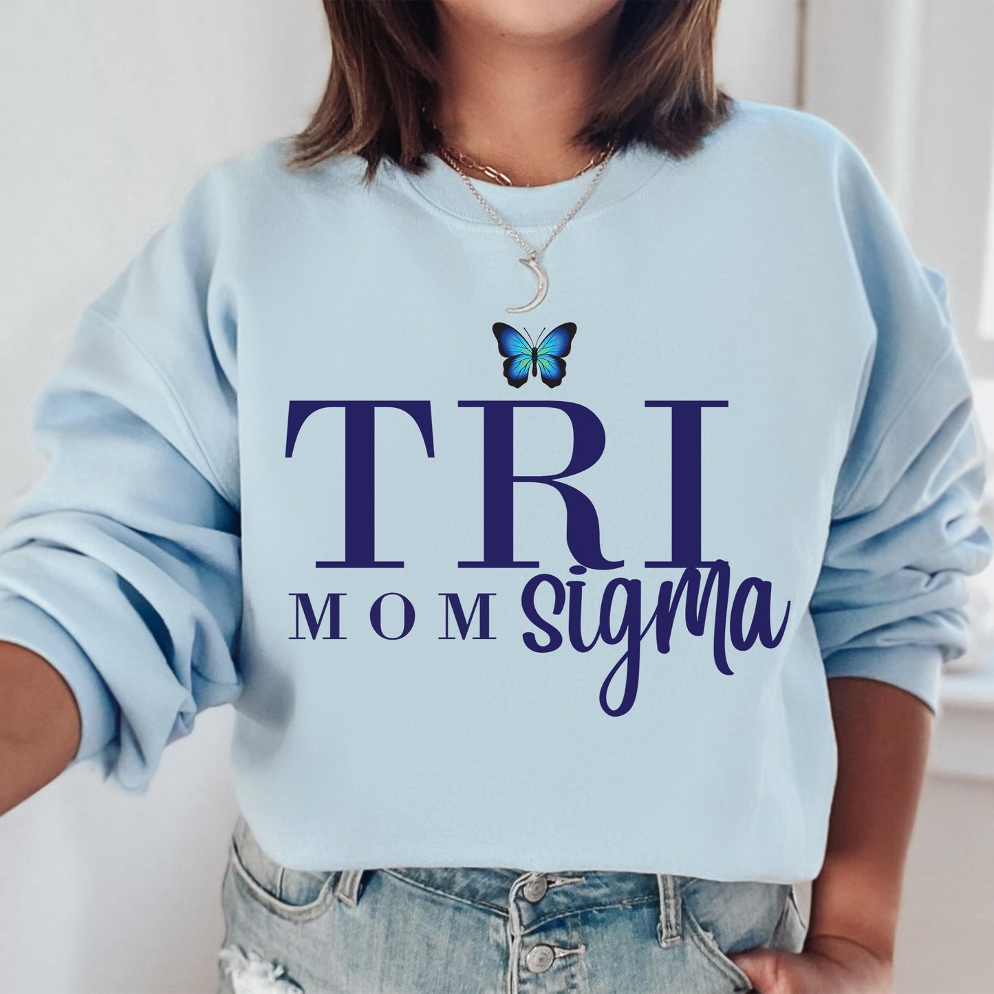 a woman wearing a blue sweatshirt with a butterfly on it