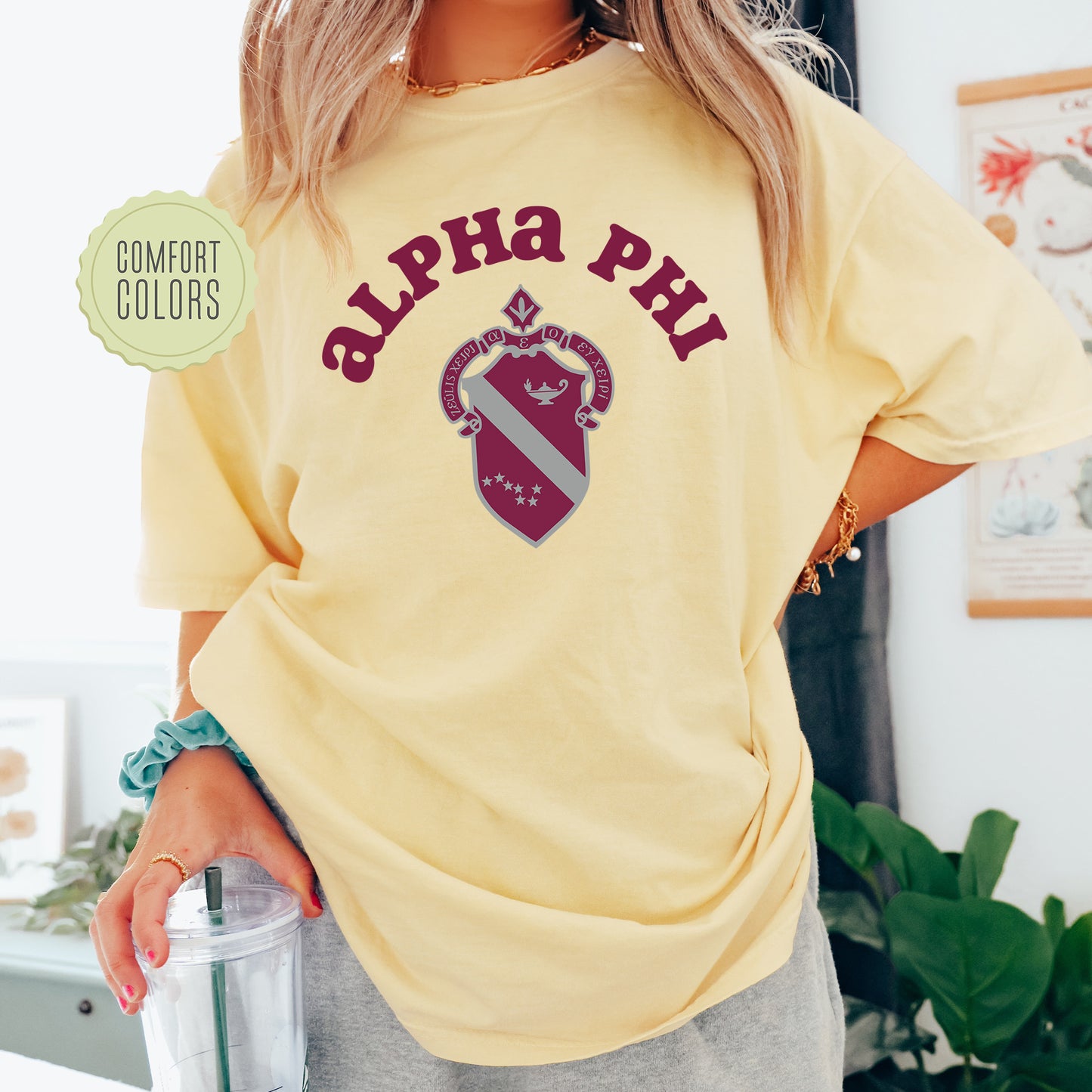 a woman in a yellow shirt holding a blender