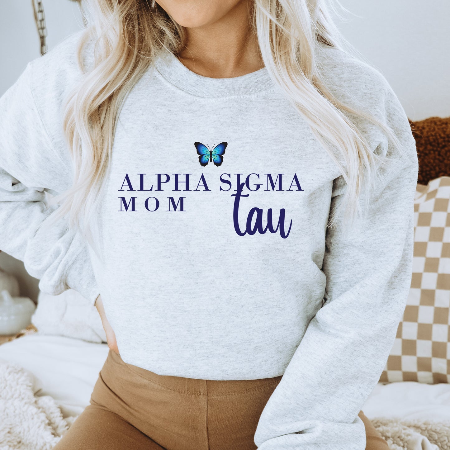 a woman wearing a sweatshirt with a butterfly on it