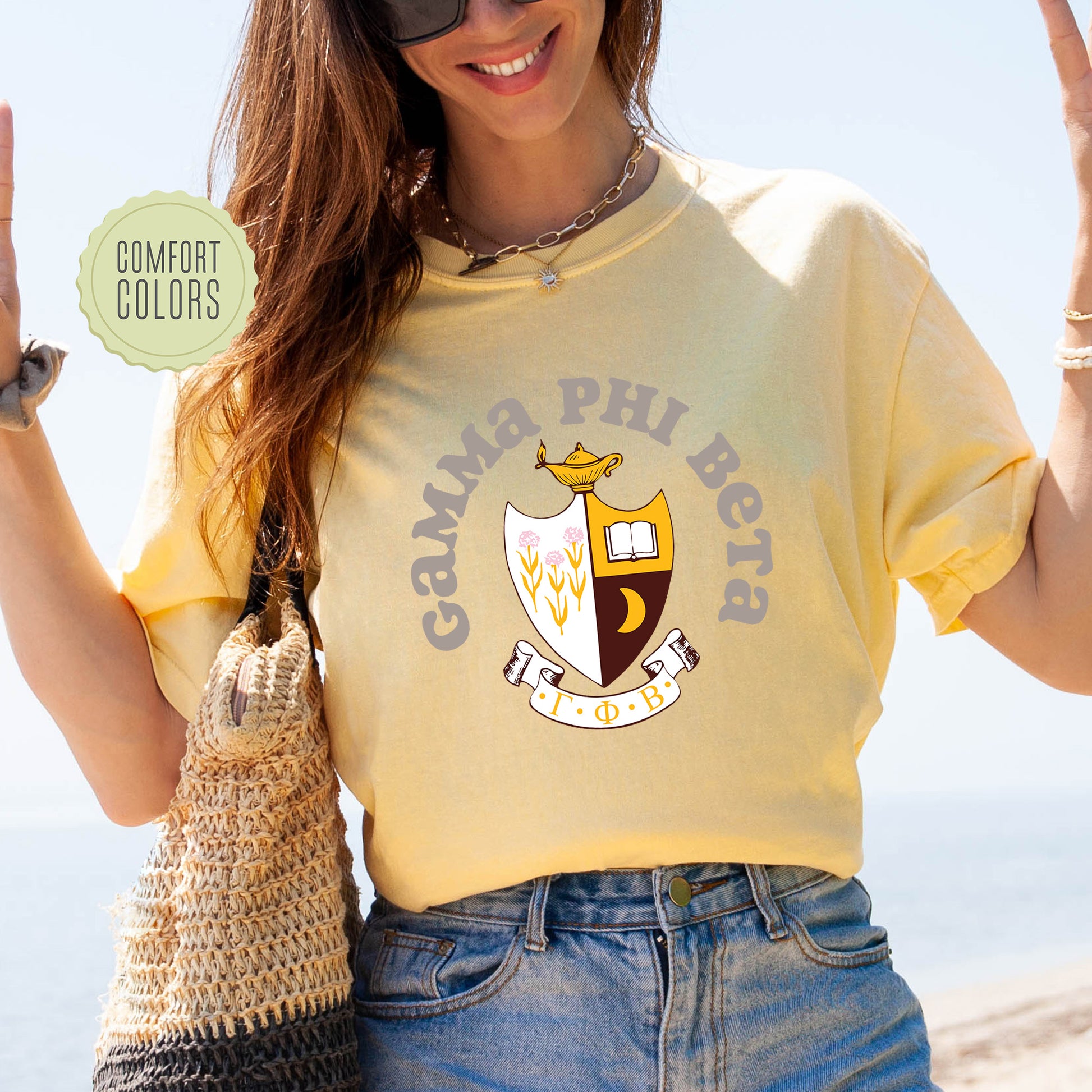 a woman in a yellow shirt holding up a peace sign