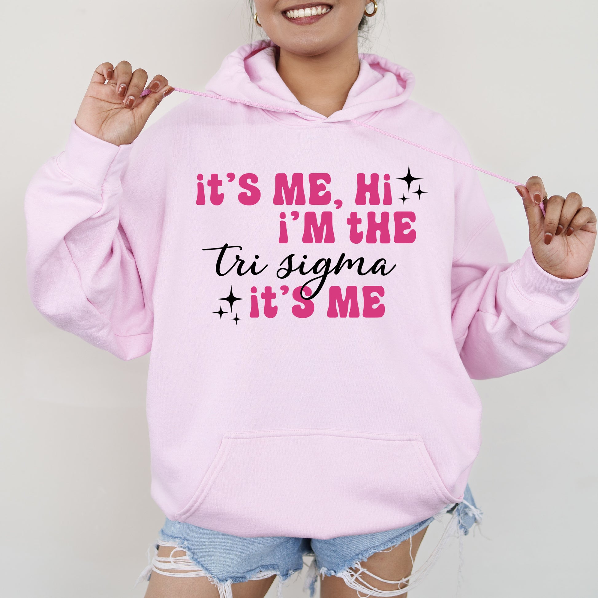 a woman wearing a pink hoodie that says it's me, i '